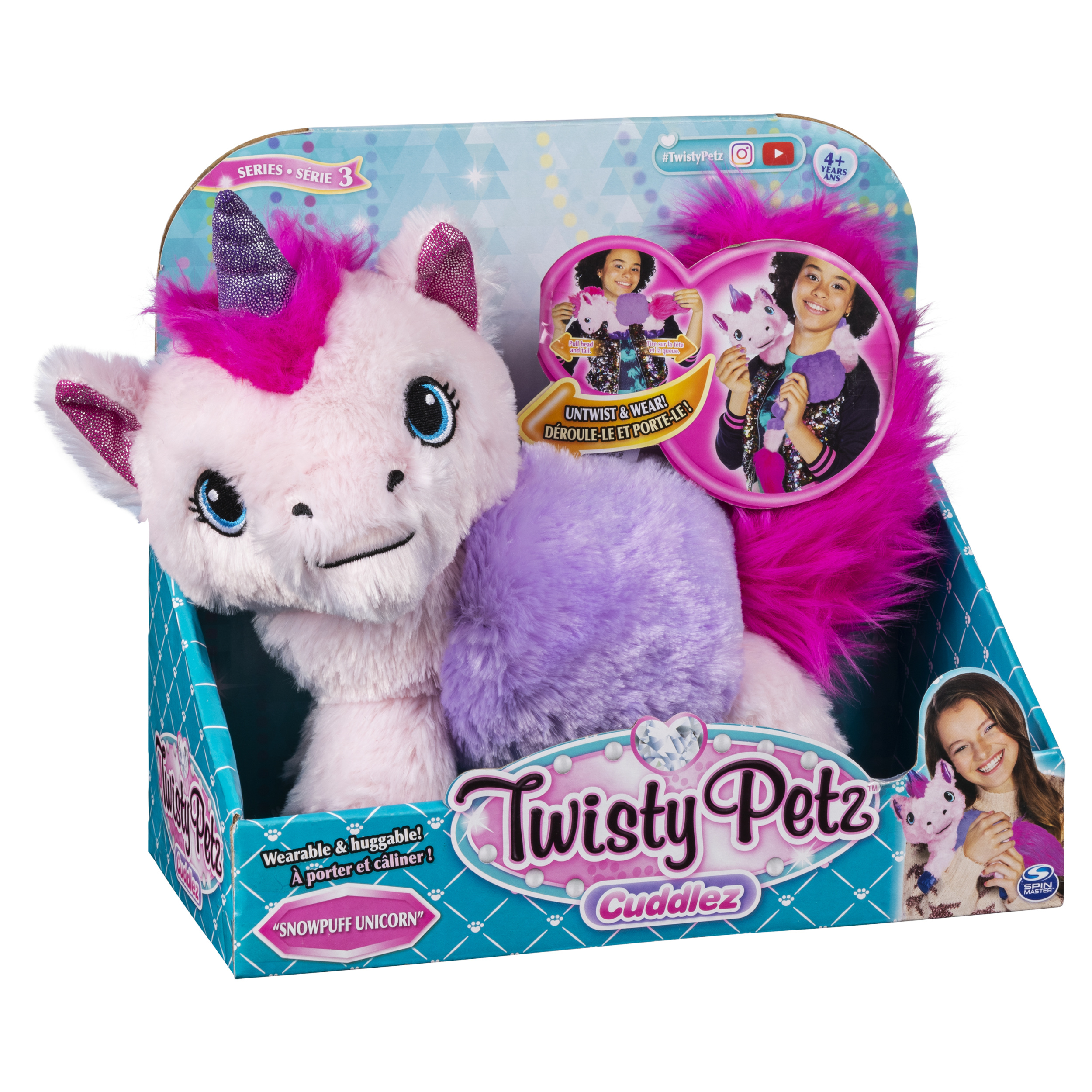 Ein Einhorn-Plüschtier in einer Box, mit lila Horn und Schwanz.