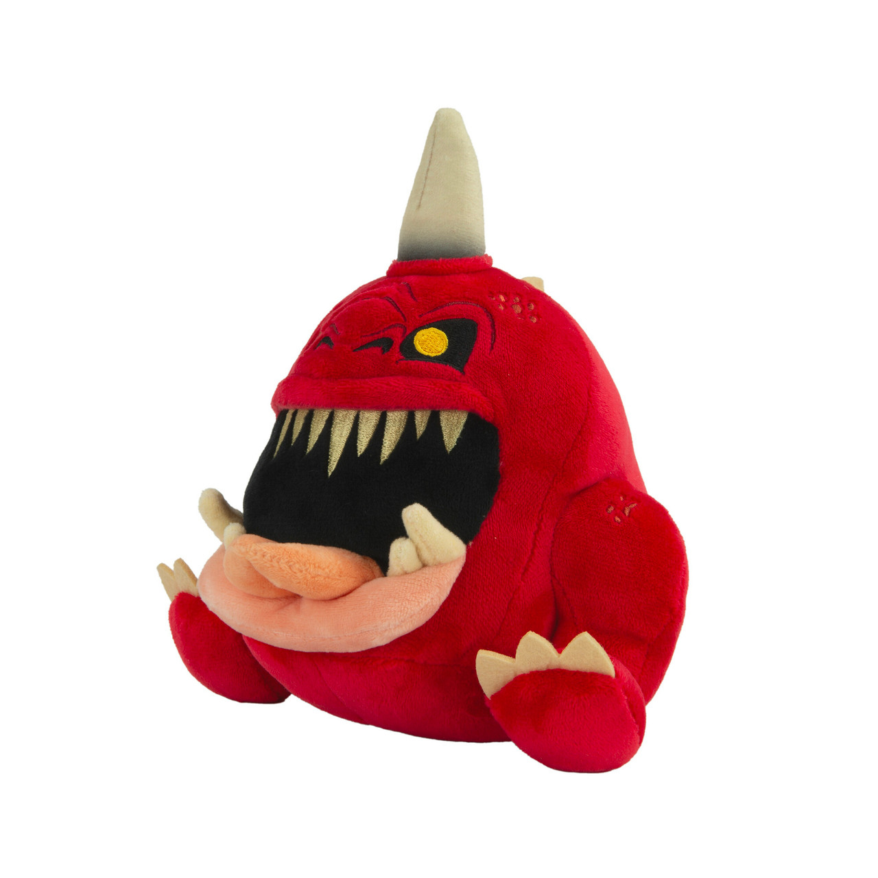 Jouet monstre en peluche rouge avec des dents blanches et une corne. Fond blanc.
