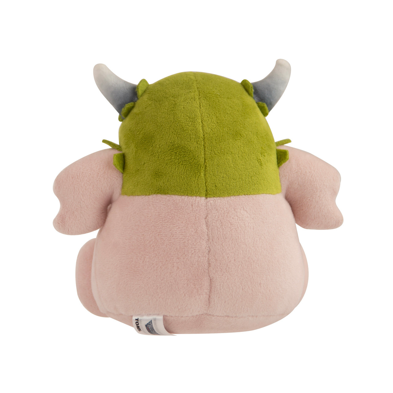 Un peluche, vista posteriore, di un mostro con testa verde, corpo rosa e corna grigie, seduto su sfondo bianco.