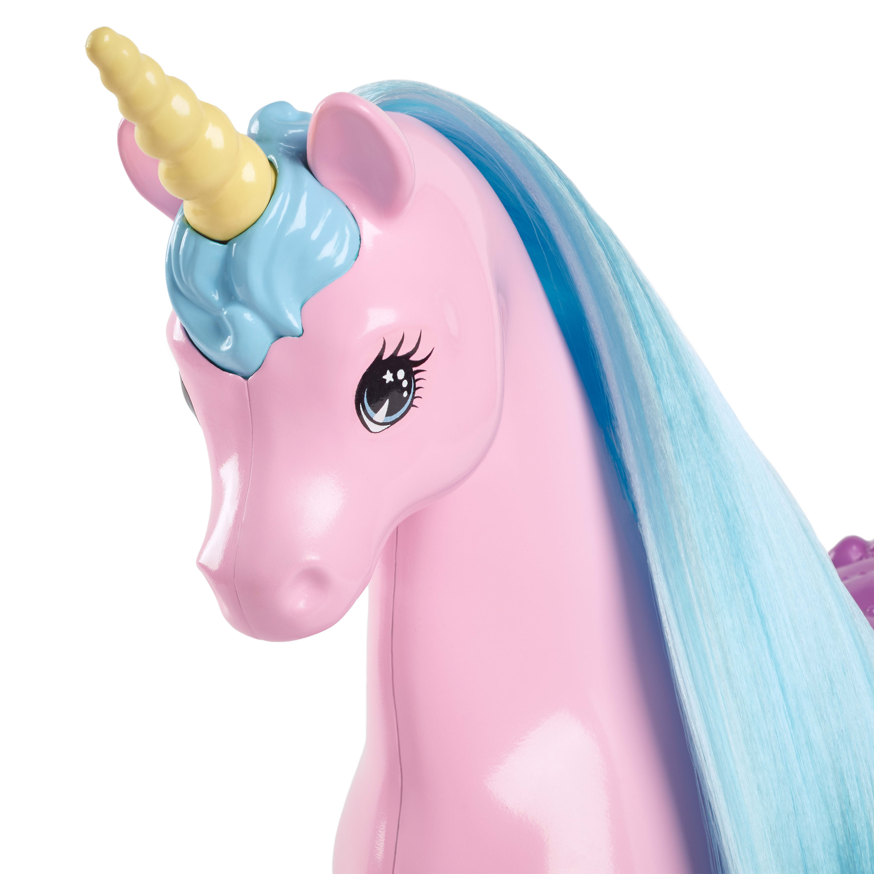 Un juguete de unicornio rosa con un cuerno amarillo y una melena azul.