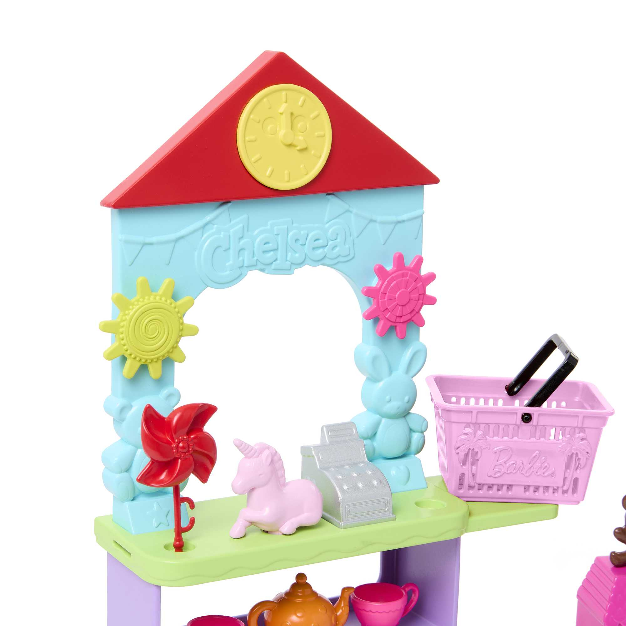 Ein Spielzeugladen-Set mit verschiedenen bunten Elementen. Ein pinkes Einhorn und eine Kasse sind sichtbar.