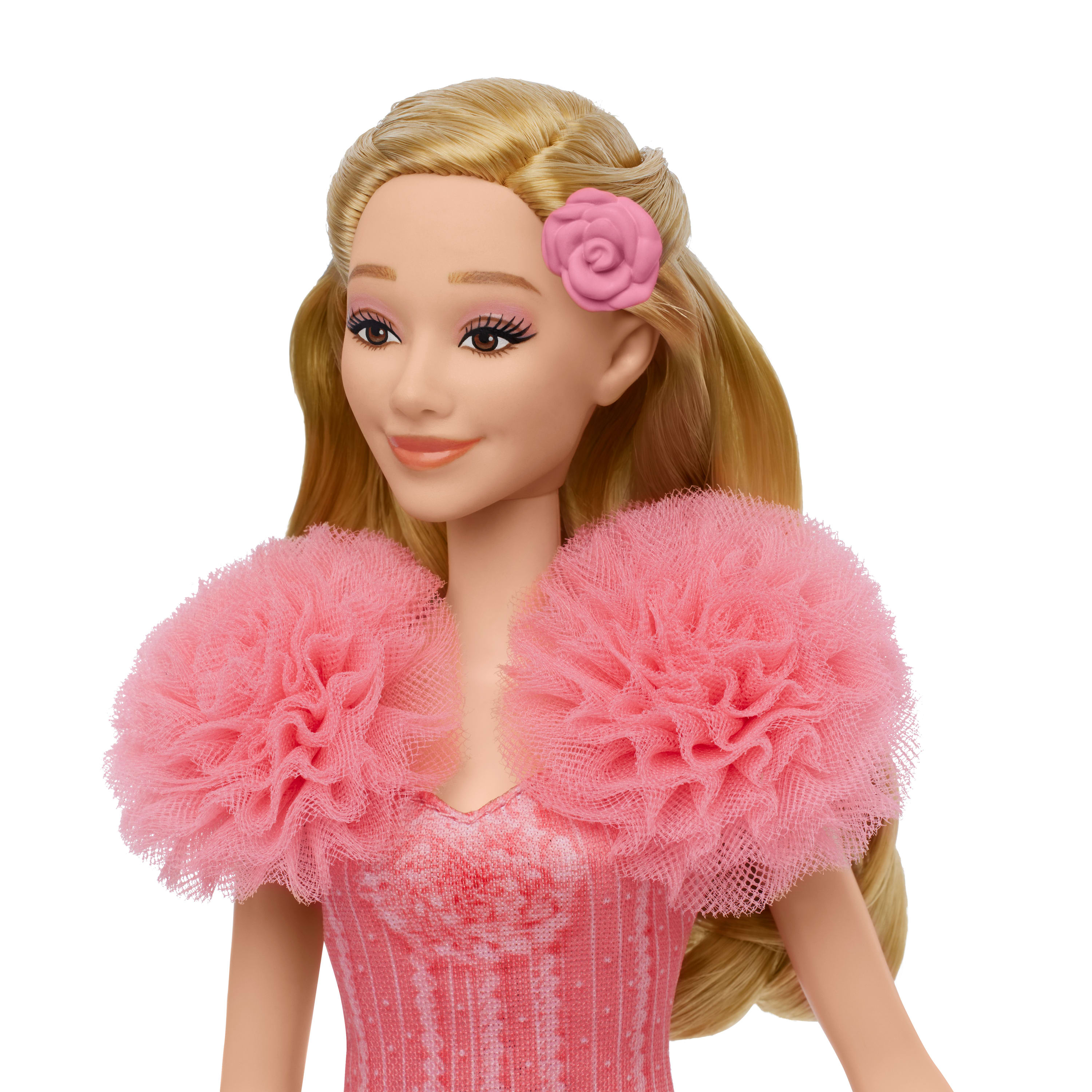 Nahaufnahme eines Puppengesichts mit einer rosa Blume im Haar.