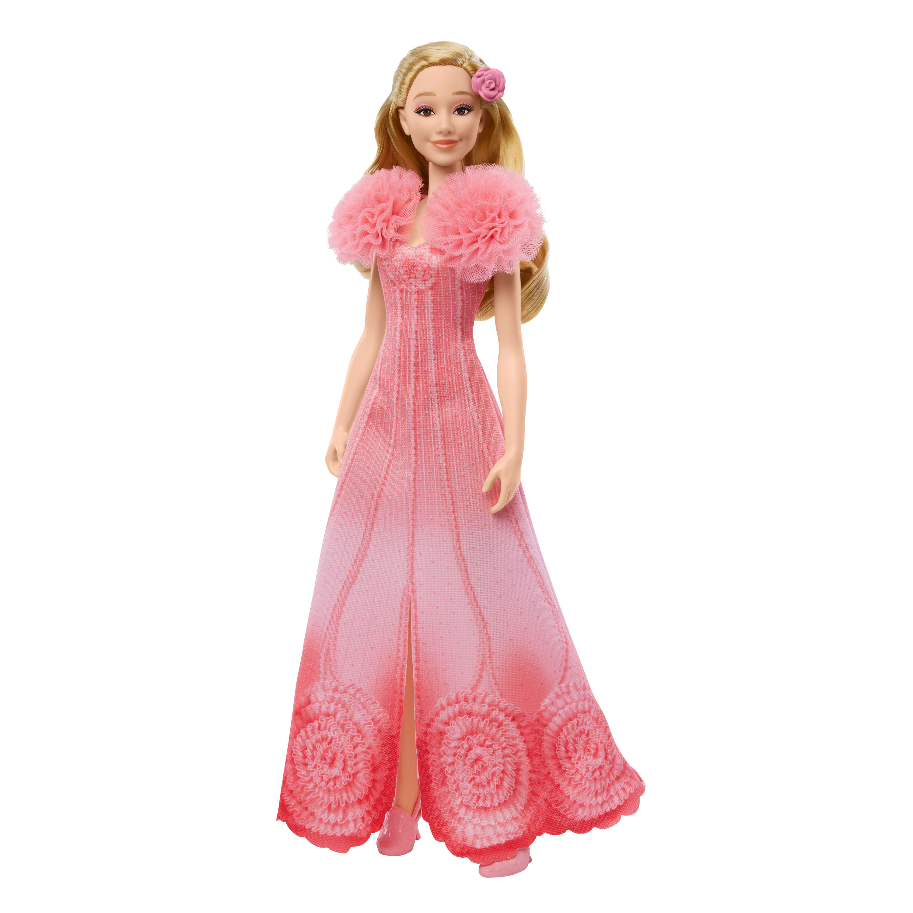 Eine Puppe in einem rosa Kleid mit einer rosa Blume im Haar.