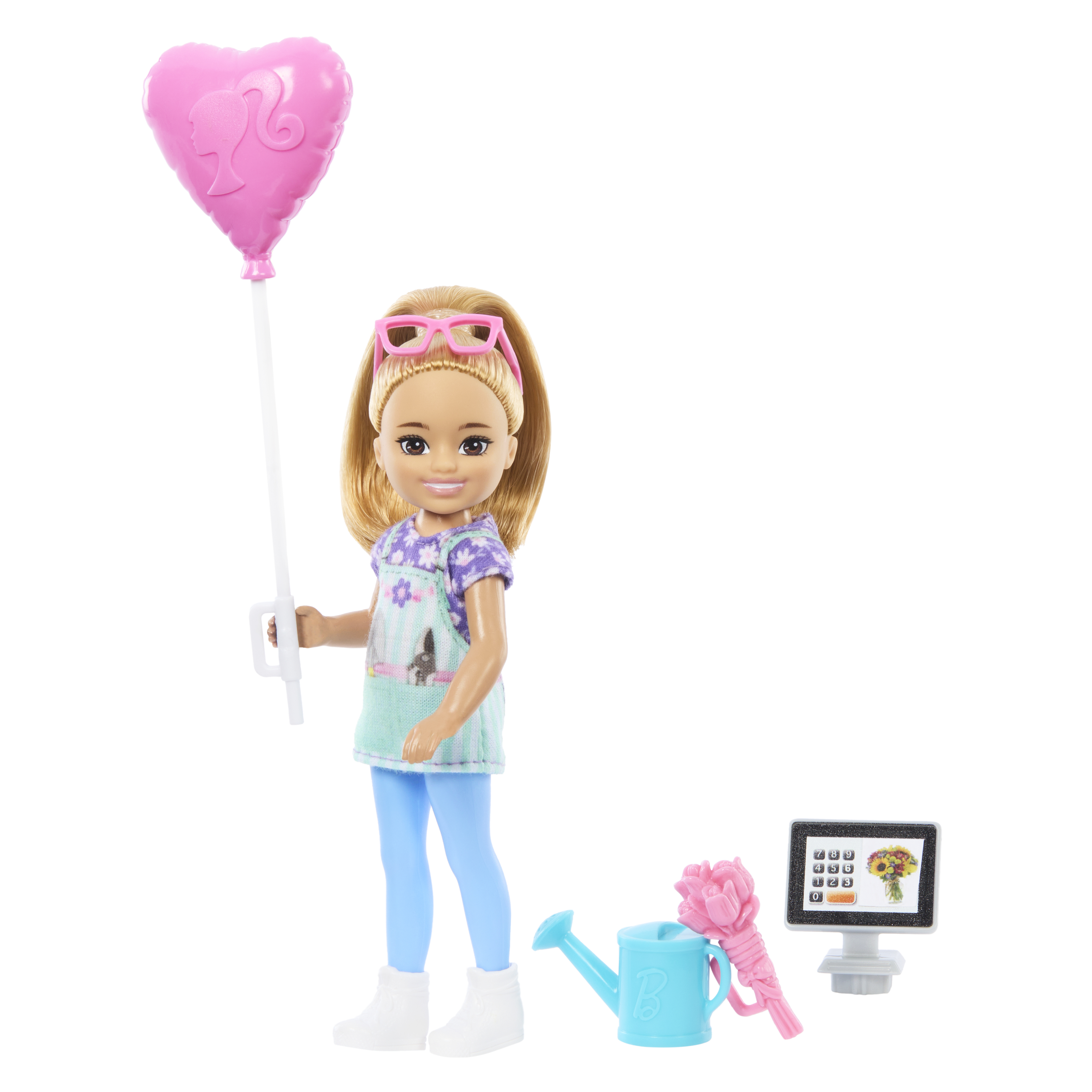 Puppe mit blondem Pferdeschwanz, Brille und Schürze, hält einen rosa Herzballon und Zubehör.
