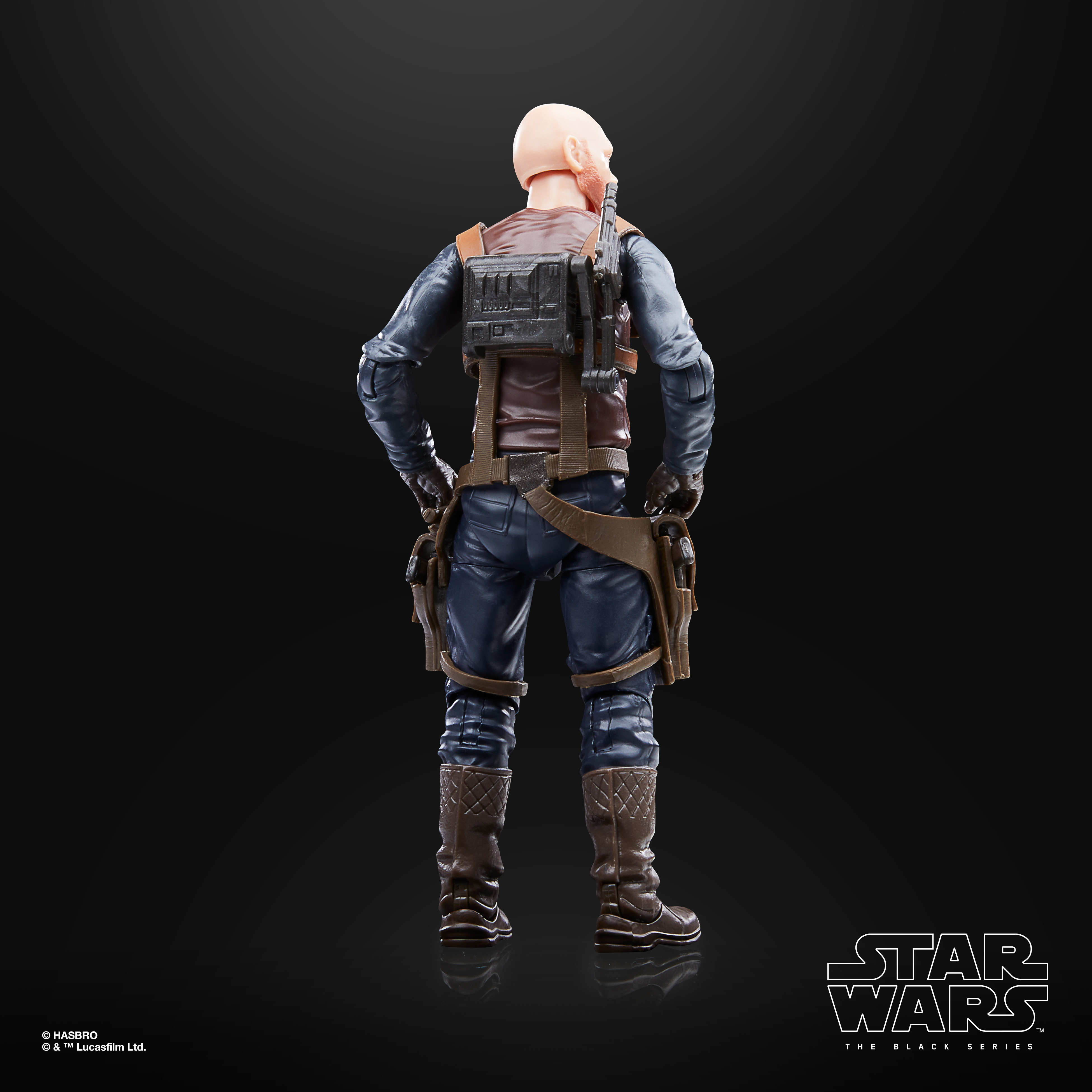 Rückansicht einer Star Wars-Actionfigur. Glatzköpfig, mit brauner Weste und blauer Hose. Hat einen Rucksack und zwei Halfter.