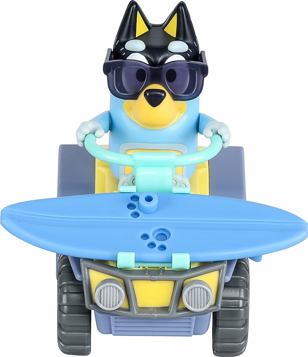 Bluey hondenspeelgoed op een gele ATV met een surfplank. Het heeft een zonnebril en een lichtblauw stuur.