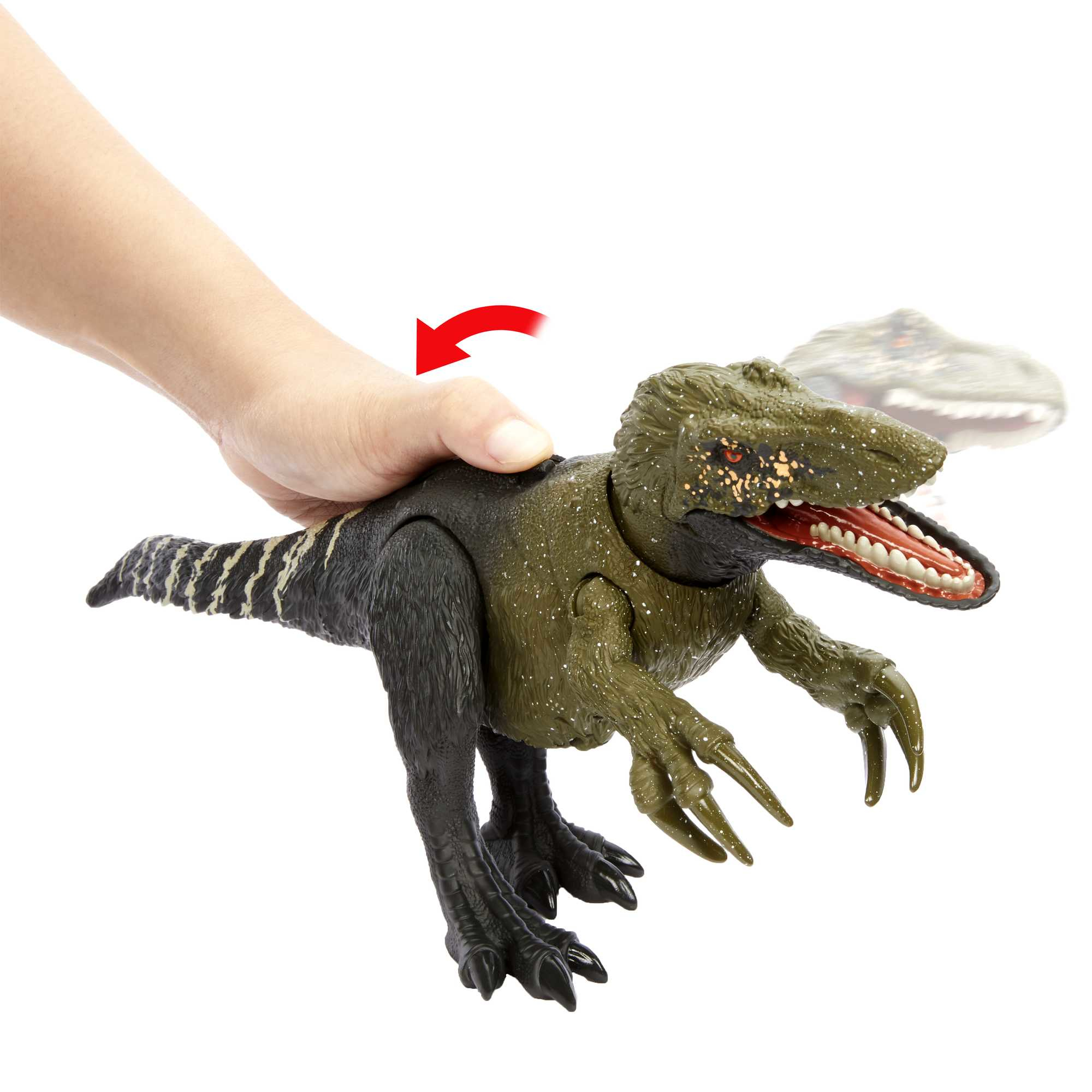 Una mano che gira un giocattolo di dinosauro. Il giocattolo è verde e nero con una freccia rossa che indica il movimento.