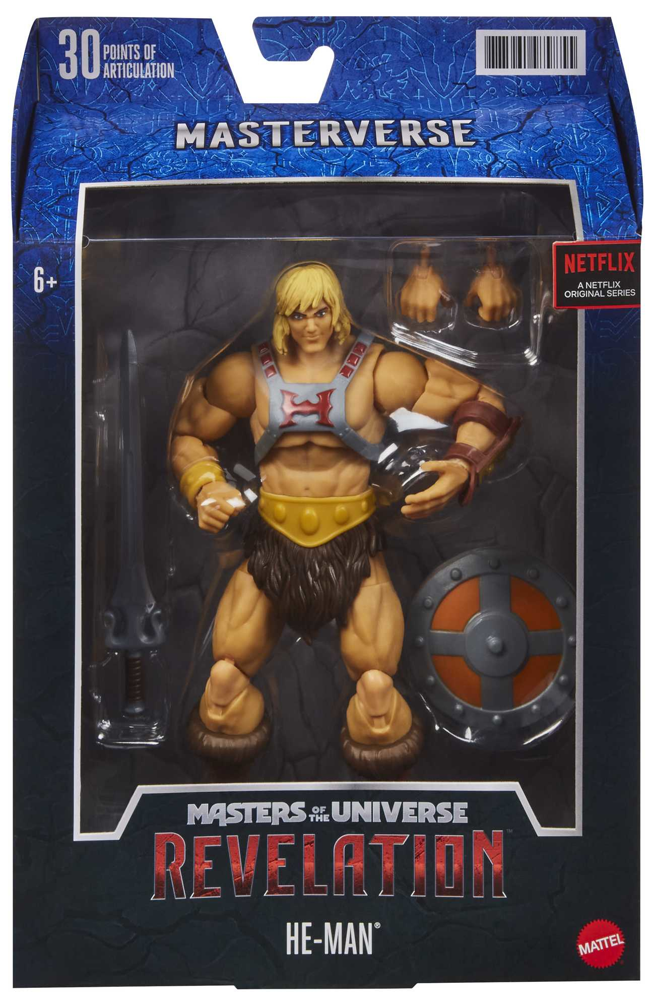 Figura de acción de He-Man en una caja. Es musculoso y sostiene una espada y un escudo. La caja es azul.