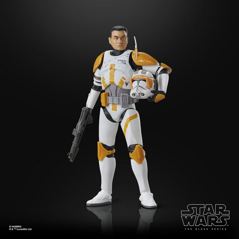 Star Wars figürü: beyaz ve turuncu zırh, kask tutuluyor, siyah zemin, elde silah.