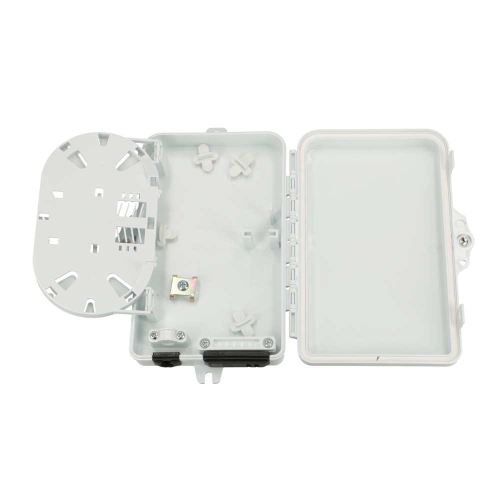 Otwarta biała skrzynka z przegródkami. Okrągły obszar po lewej i przezroczysty plastik po prawej.