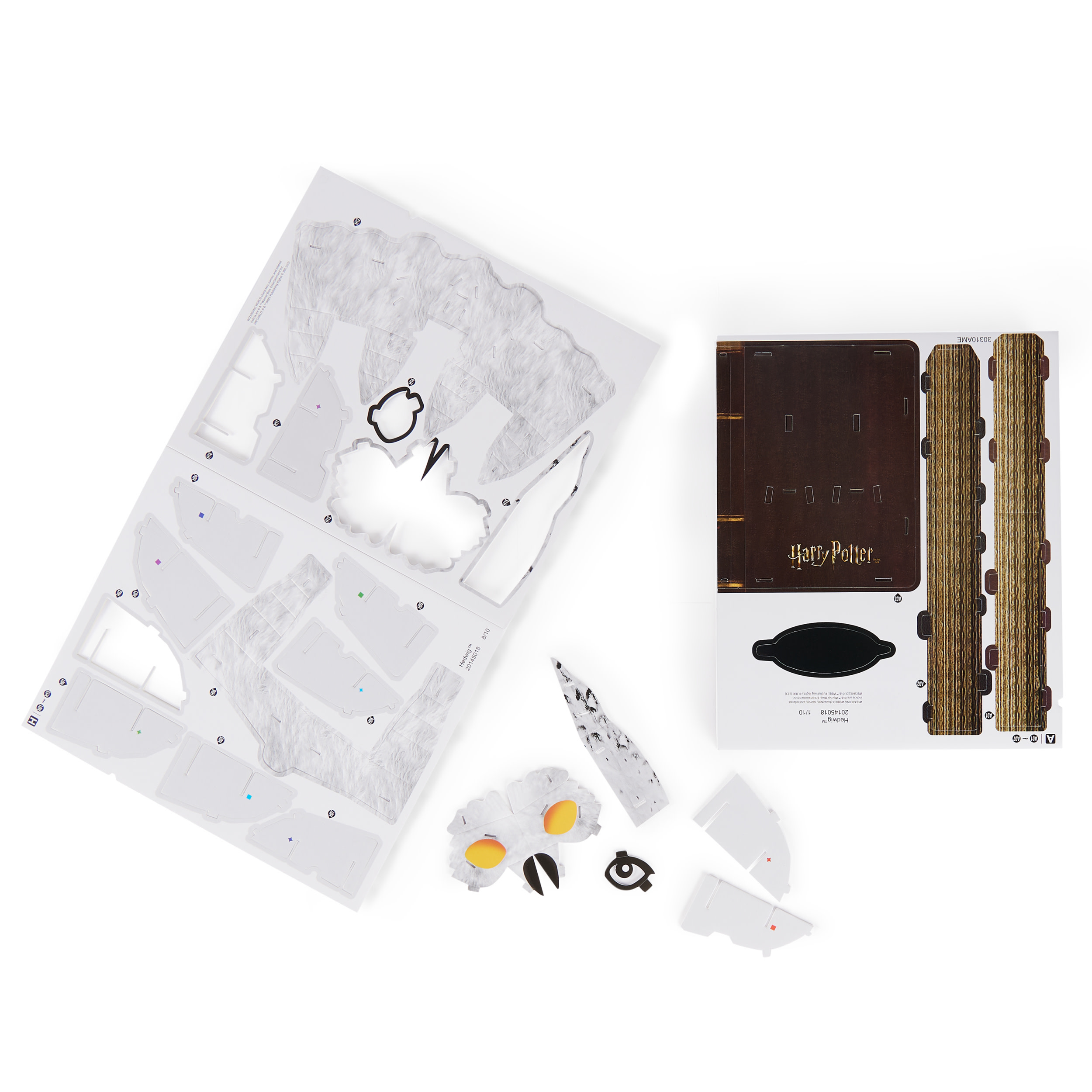 Zestaw puzzli z motywem Harry'ego Pottera z różnymi elementami, w tym sową i okładką książki.