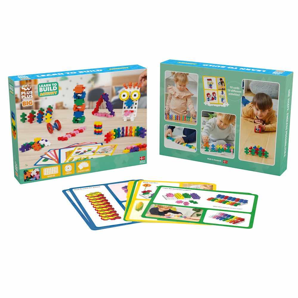 Ein Spielzeug-Bausteinset mit bunten Blöcken, Karten und Verpackung auf weißer Oberfläche.