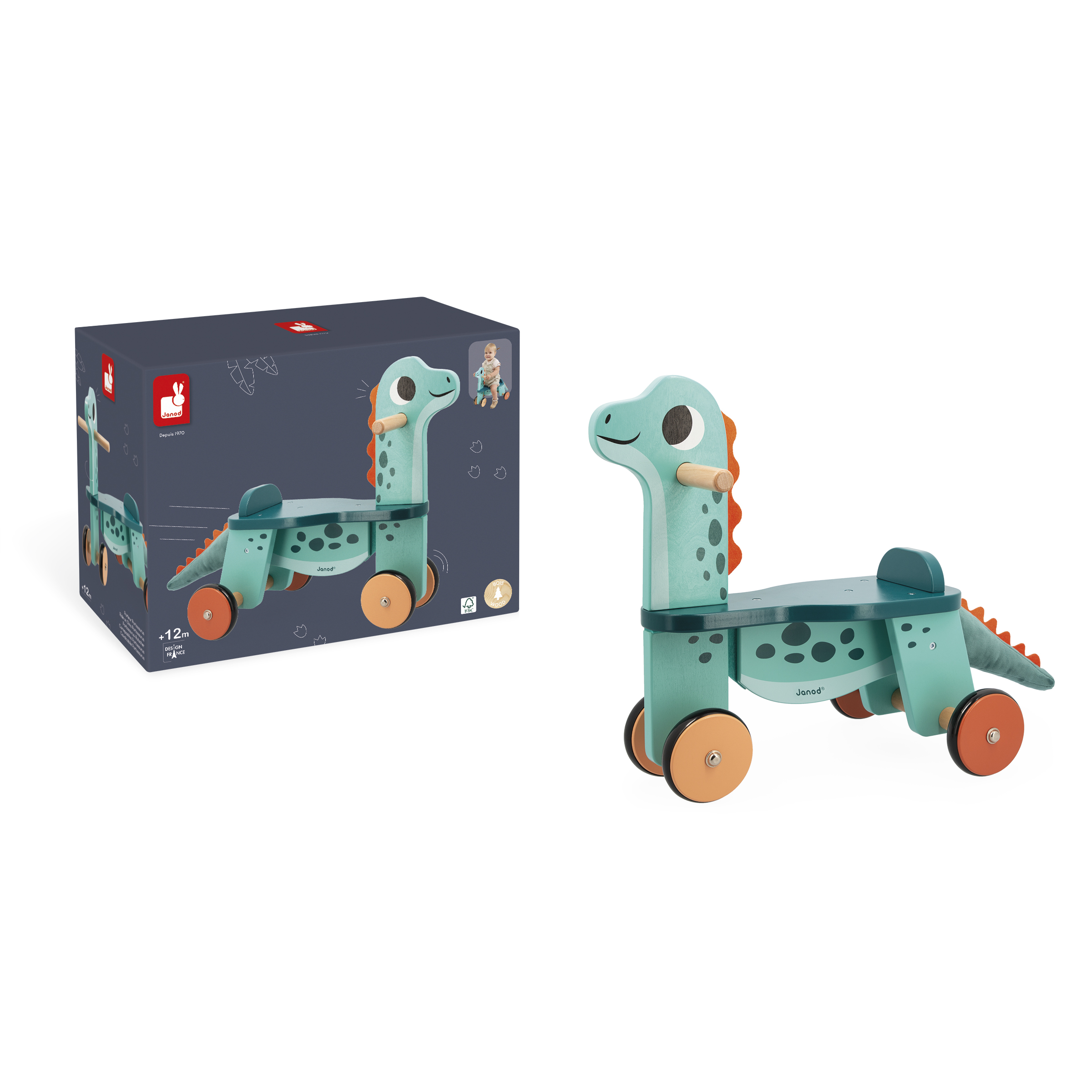 Holzspielzeug-Dinosaurier auf Rädern, neben seiner Box. Grüner Körper mit orangefarbenen Akzenten. Blaue Box.