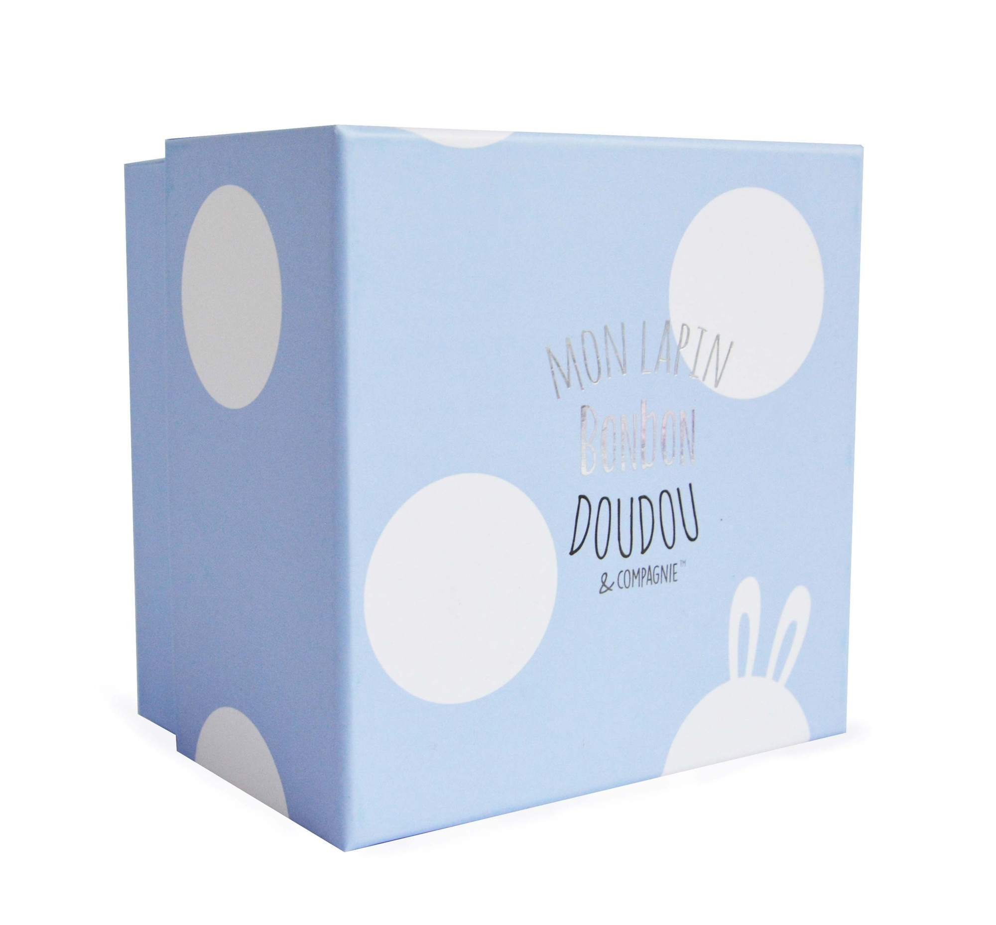 Niebieskie pudełko z białymi kropkami i francuskim tekstem: Mon Lapin Bonbon Doudou & Compagnie, uszy królika.