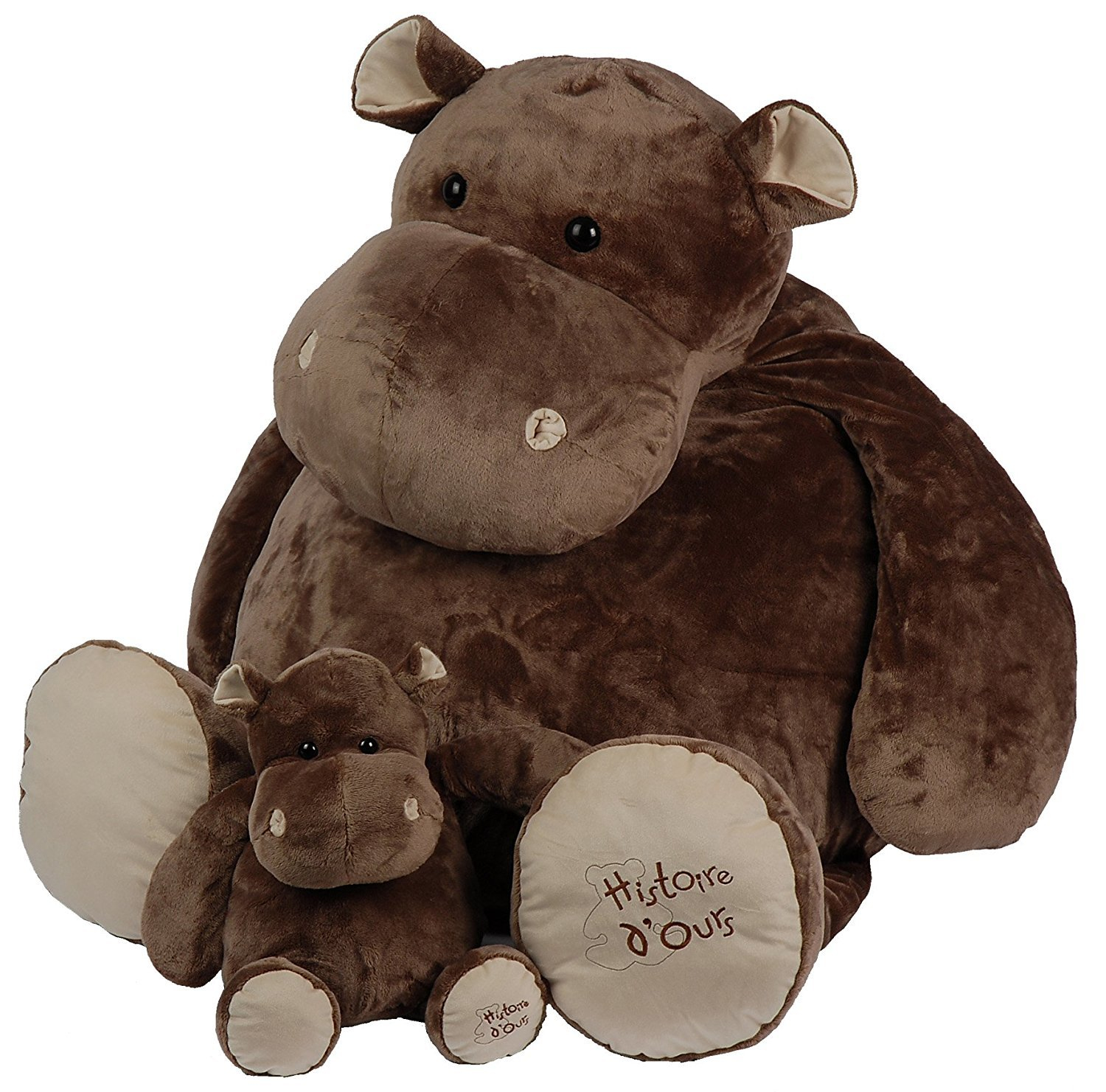 Dwie brązowe pluszowe hipopotamy. Jedna duża i jedna mała, siedzące obok siebie.