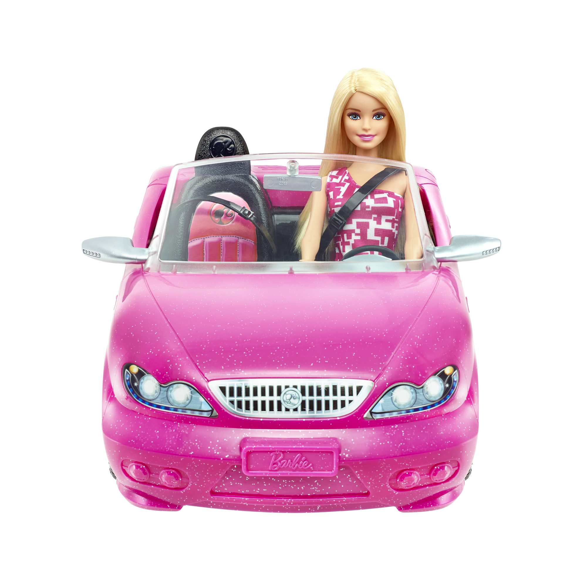 Lalka Barbie prowadzi różowy samochód, ubrana w różowo-białą sukienkę. Czarne siedzenie, białe tło.