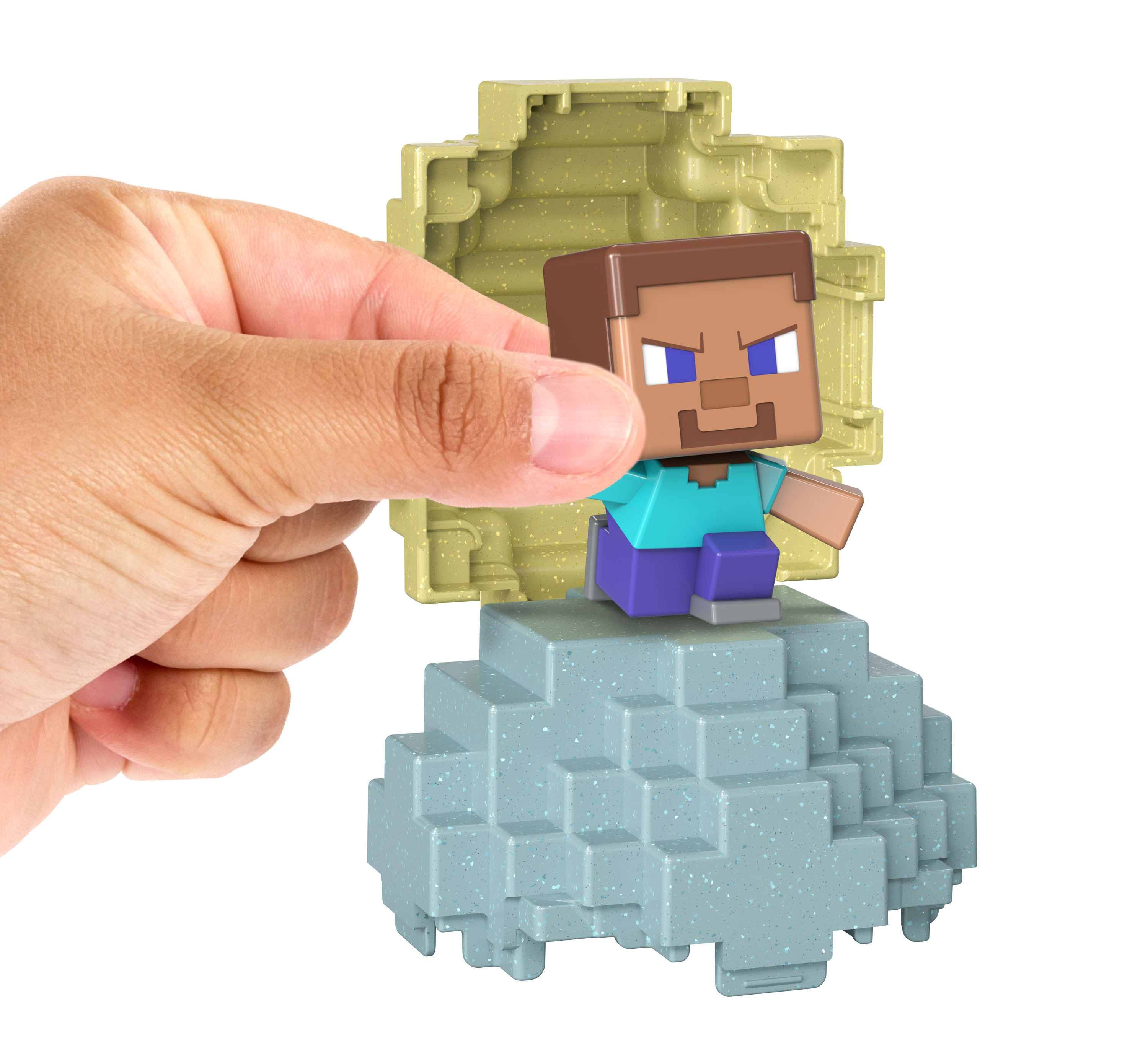 Ręka trzymająca figurkę Steve'a z Minecrafta wychodzącą z bloku.