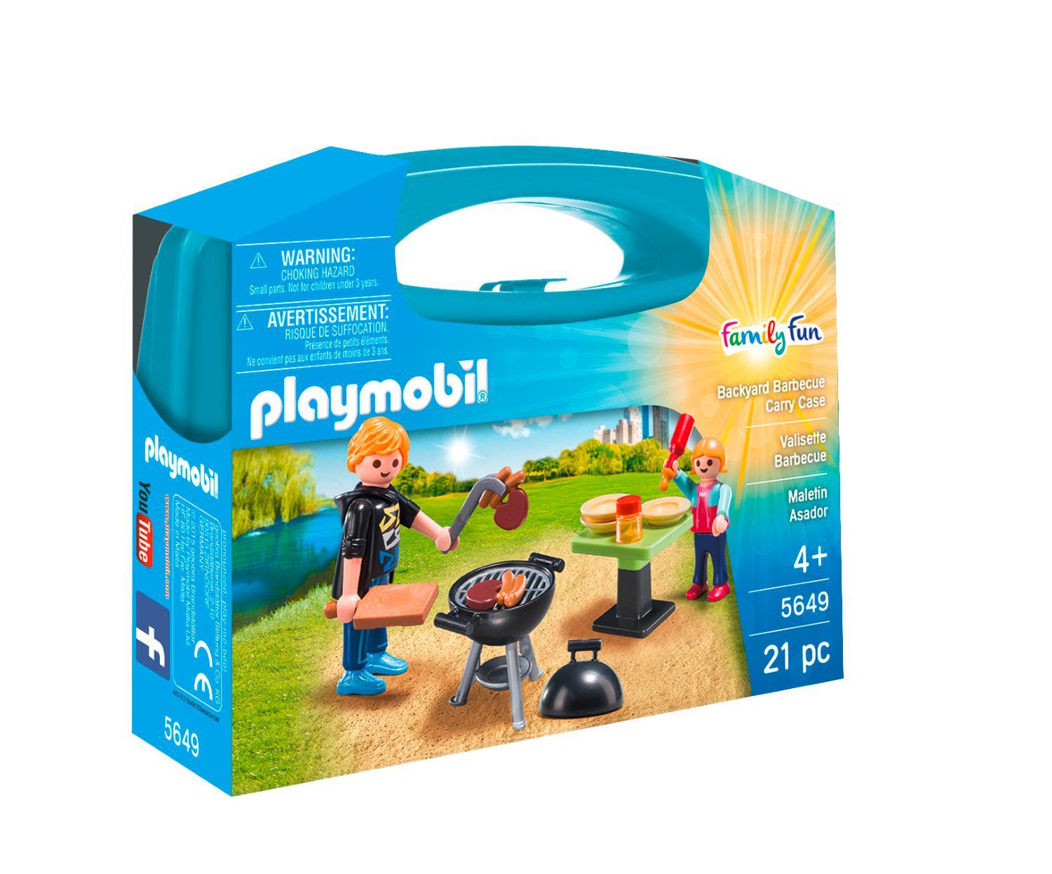 Ein Playmobil Family Fun Set mit Figuren, einem Grill und Essen auf einem Tisch.