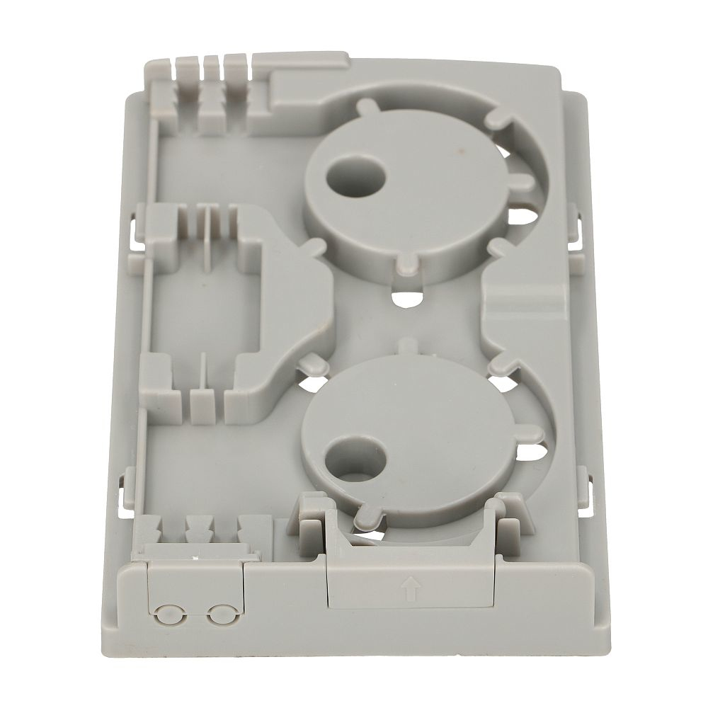 Szare wnętrze obudowy światłowodu z okrągłymi i prostokątnymi wycięciami, białe tło.