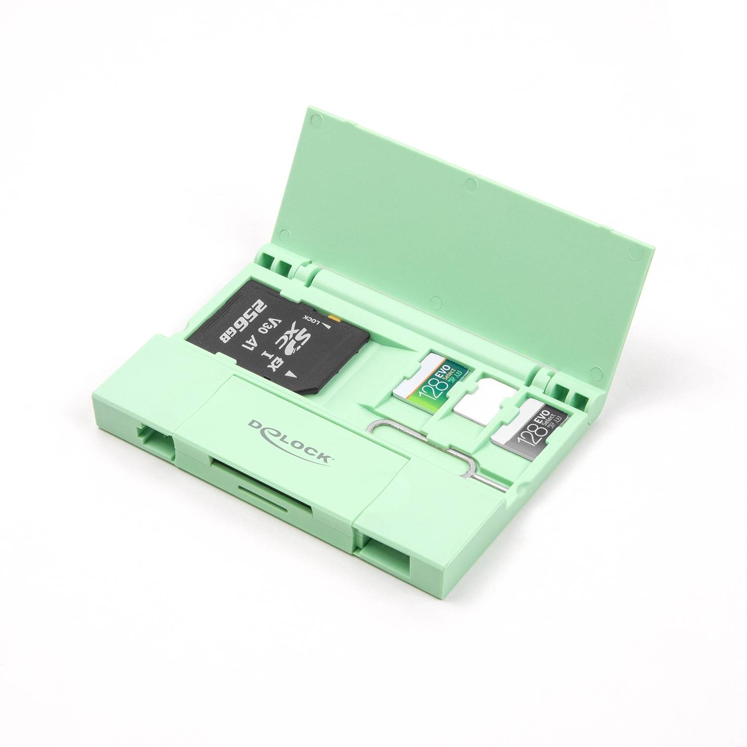 Otwarta zielona obudowa z kartami SD, kartą micro SD i wyjmakiem karty SIM na białej powierzchni.