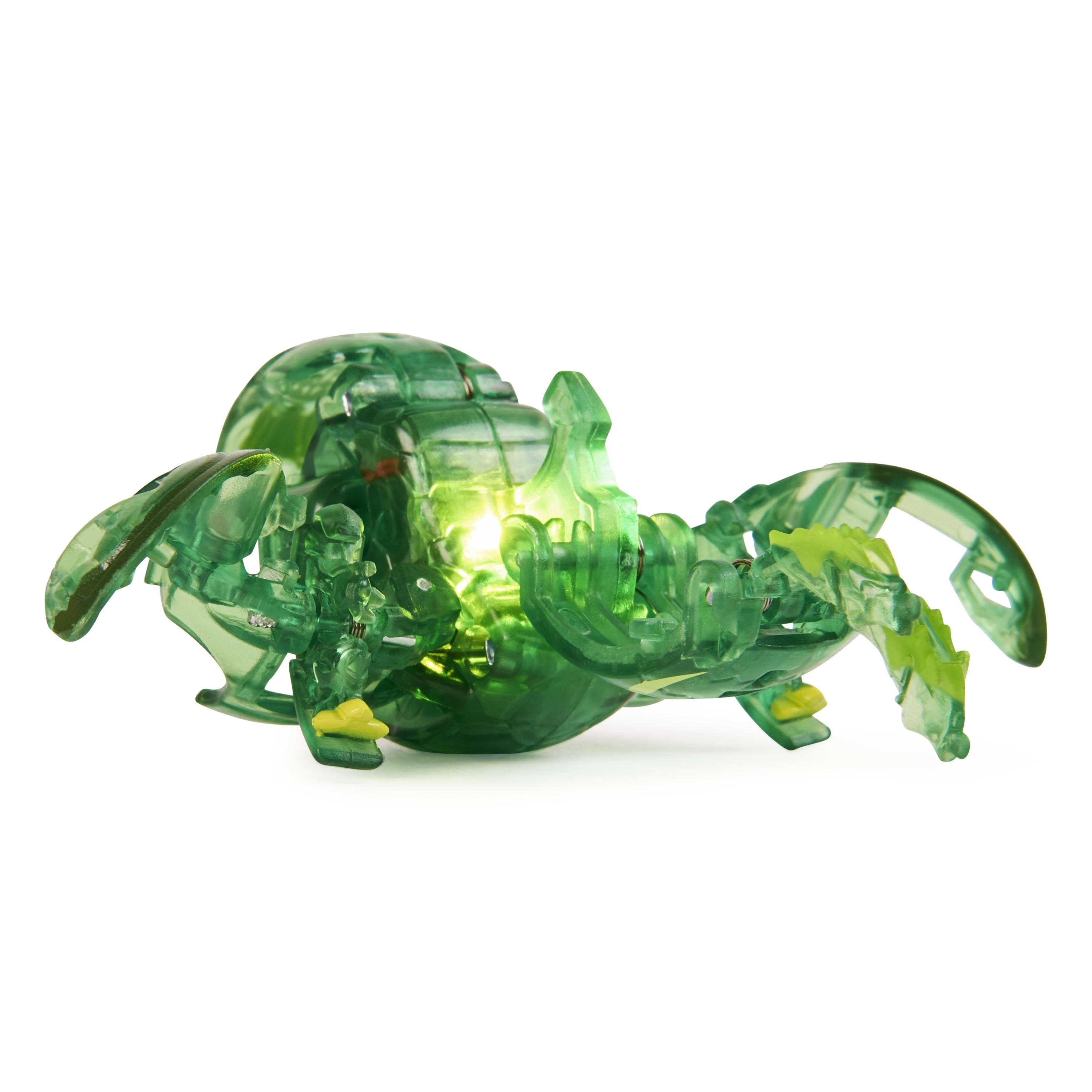 Un juguete verde transparente, iluminado desde dentro, con forma de cangrejo, con patas y un centro brillante.