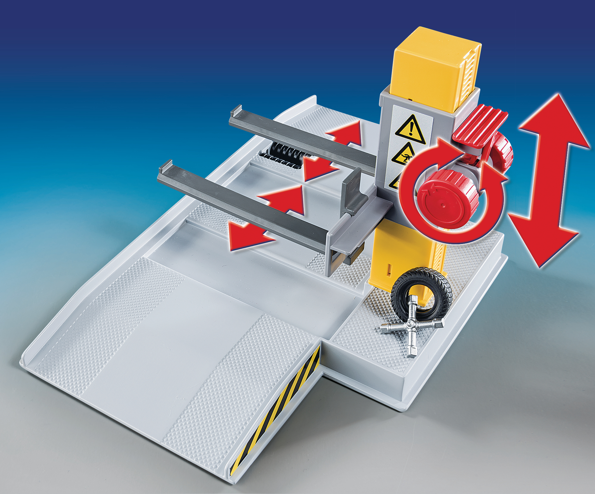 Scena garażu z zabawkami z elementami mechanicznymi, rampami i czerwoną strzałką.