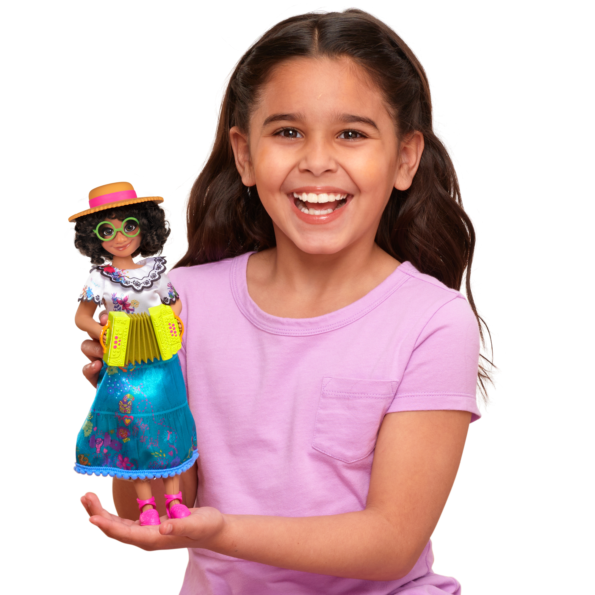 Ein Mädchen hält eine Mirabel-Puppe, beide lächeln, vor weißem Hintergrund.