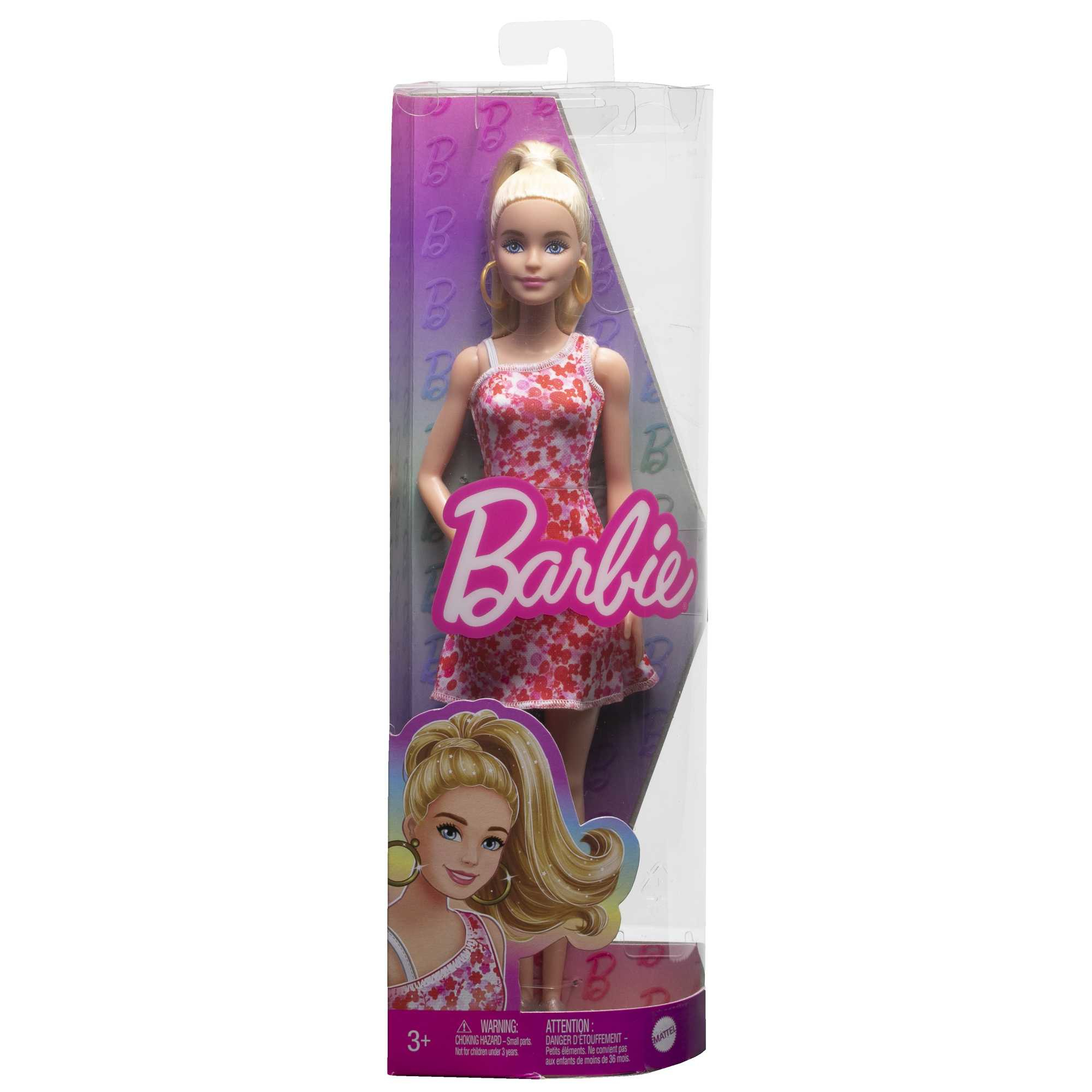 Lalka Barbie w przezroczystym plastikowym pudełku w czerwonej sukience w kwiaty.