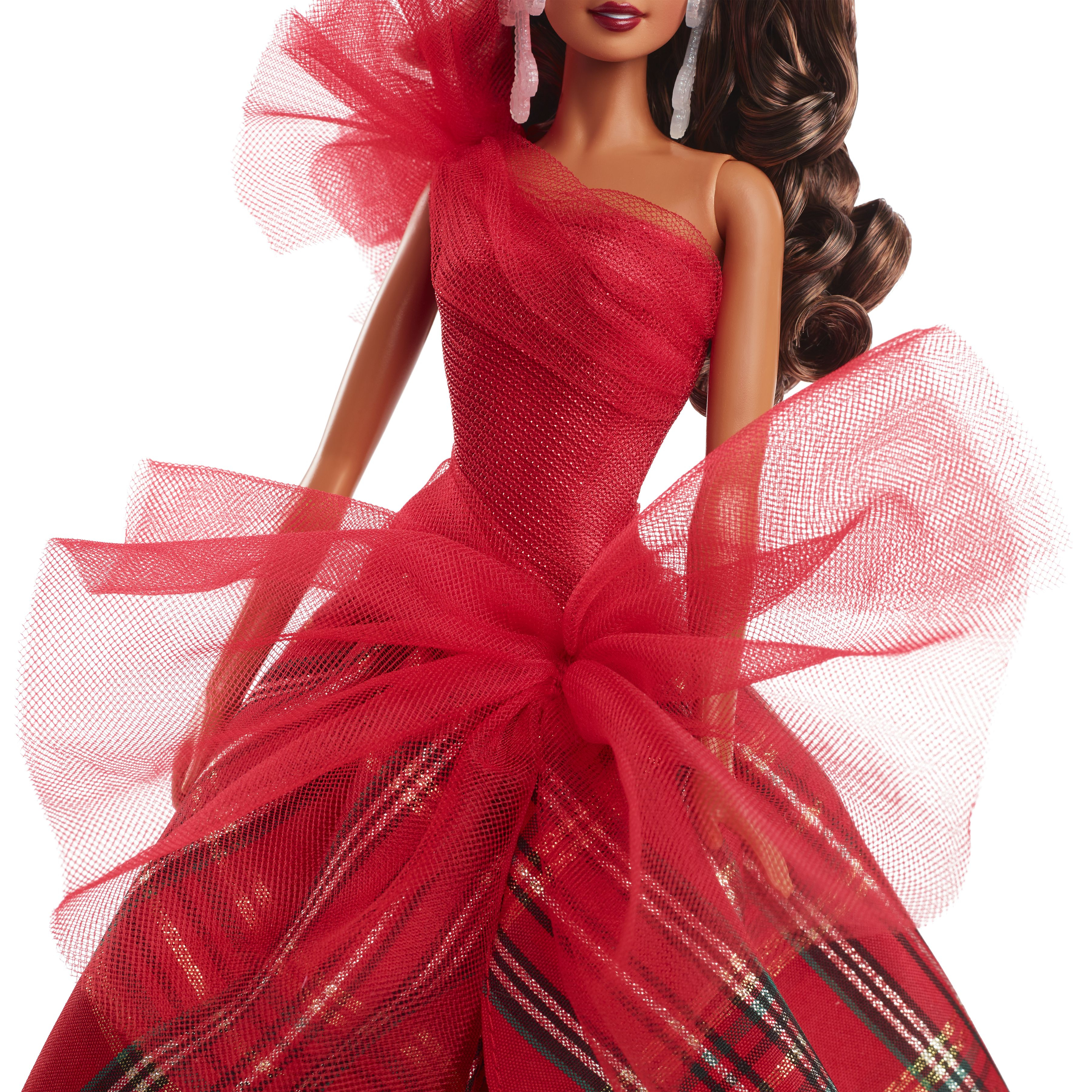 Nahaufnahme einer Barbie-Puppe in einem roten Kleid mit kariertem Rock und roter Schleife.
