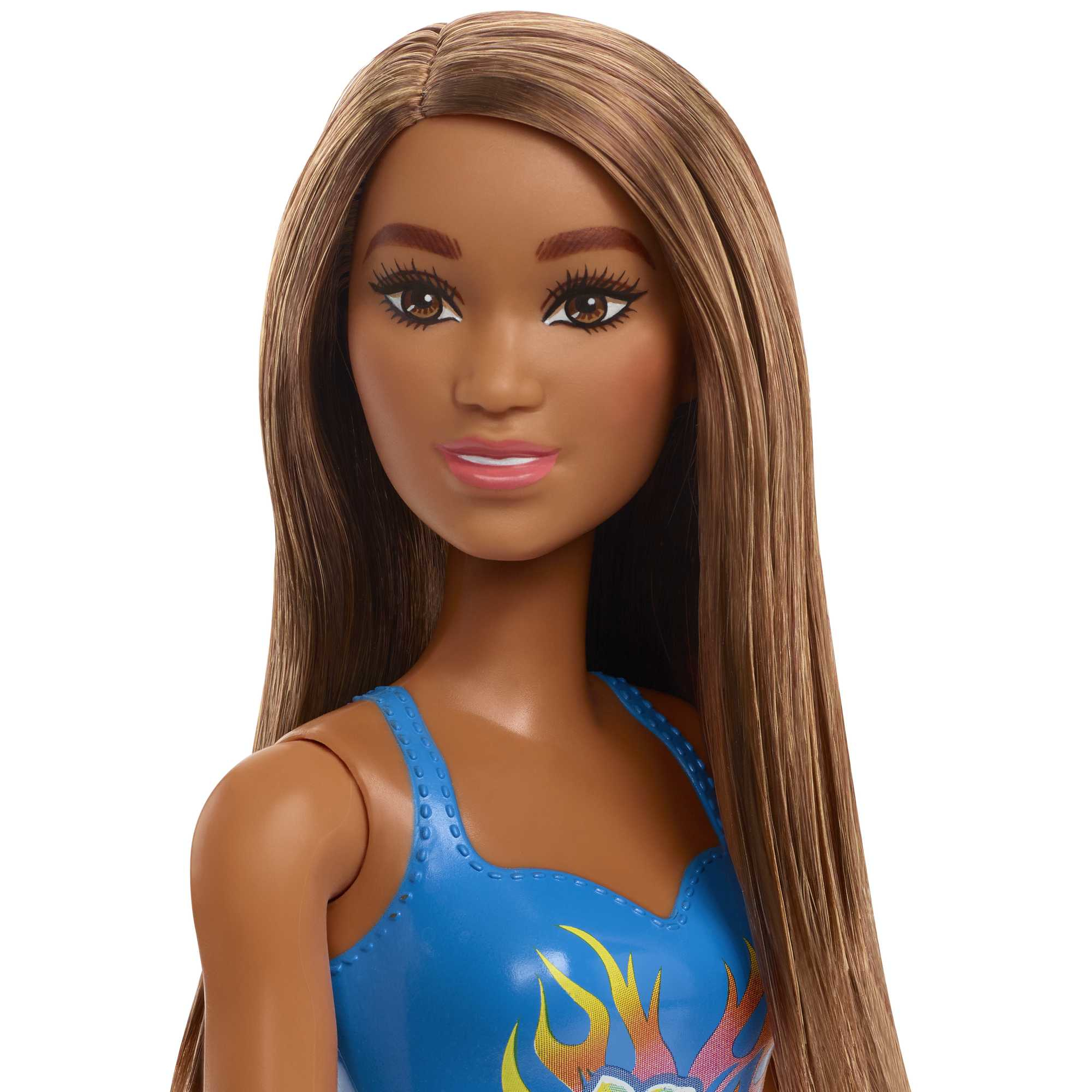 Nahaufnahme des Gesichts einer Barbie-Puppe mit langen, braunen Haaren. Sie hat braune Augen und rosa Lippen, trägt ein blaues Oberteil.