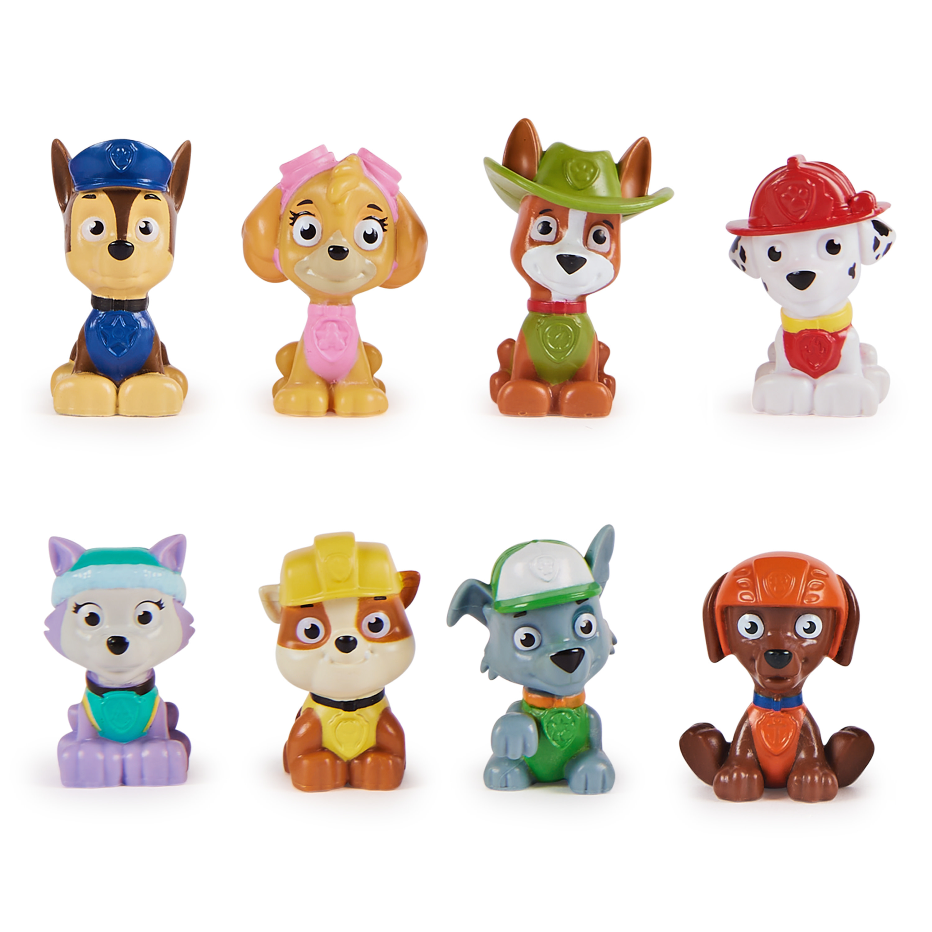 Acht Paw Patrol Figuren in verschiedenen Uniformen.