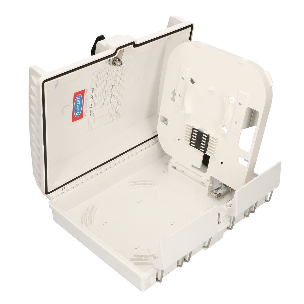 Otwarta biała skrzynka z widocznymi elementami wewnętrznymi, w tym etykietą ostrzegawczą i płytką obwodu drukowanego.