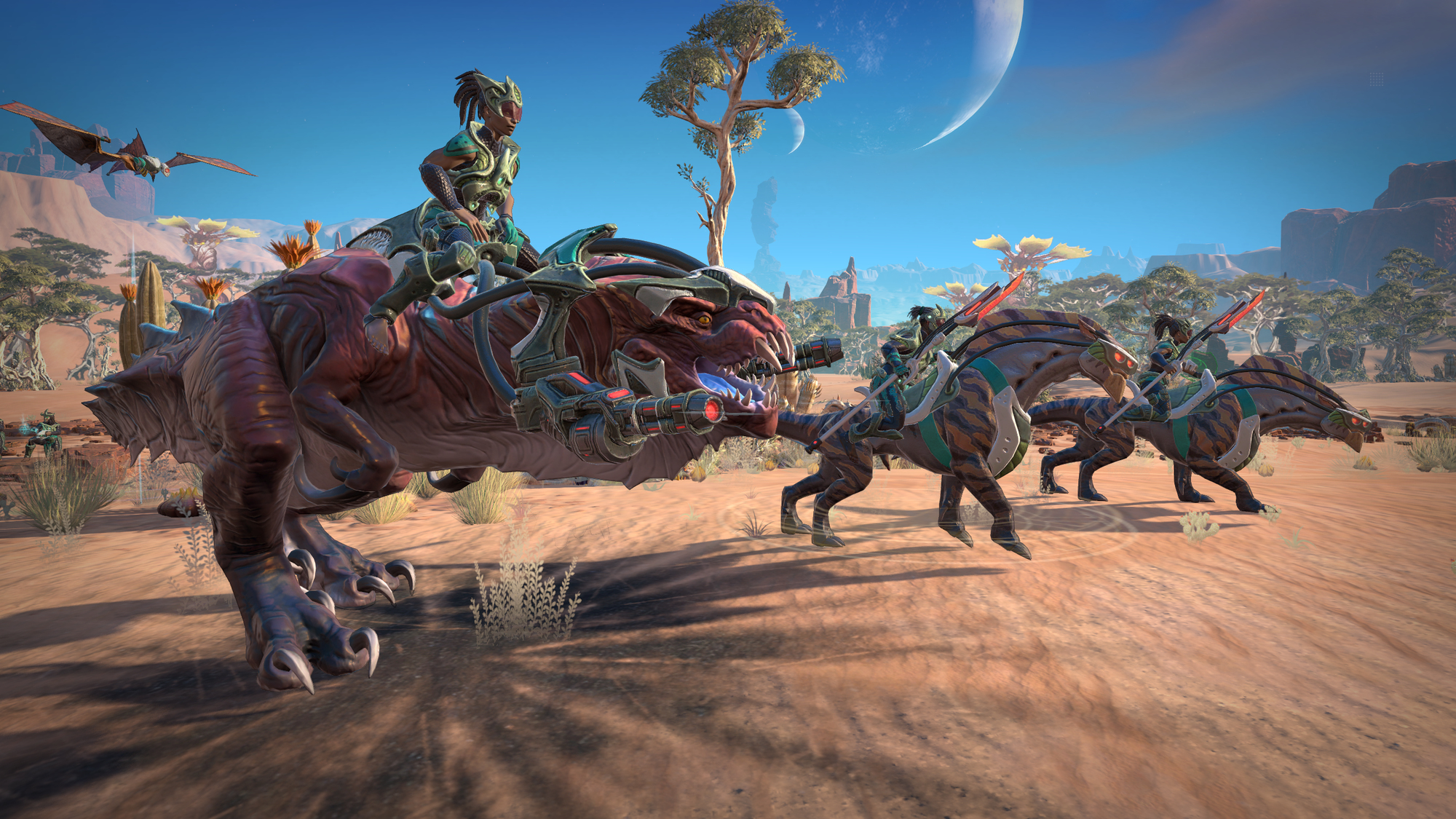 Eine Gruppe von Leuten reitet auf dinosaurierartigen Kreaturen auf einer braunen Ebene mit blauem Himmel.