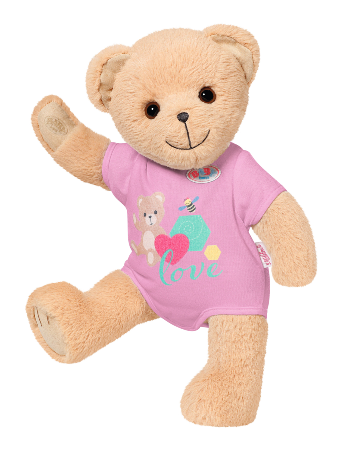 Beżowy miś w różowej koszulce z wzorem misia i pszczoły, trzymający jedno ramię w górze.