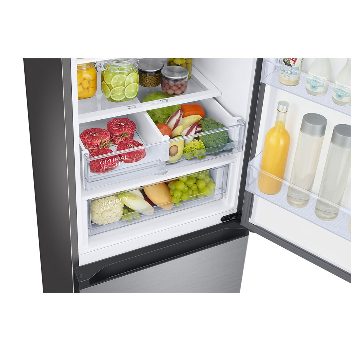 Interior del refrigerador lleno de alimentos en cajones y estantes. Incluye frutas, verduras y botellas.