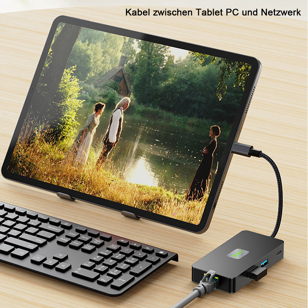 Tablet, das ein Video zeigt, verbunden mit einem USB-Hub und Tastatur auf Holzoberfläche.