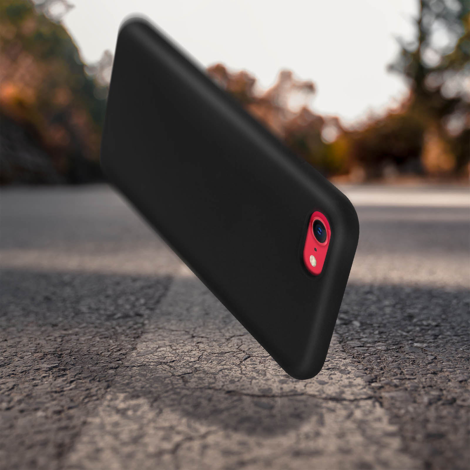 Custodia nera sul pavimento. Anello fotocamera rosso visibile.