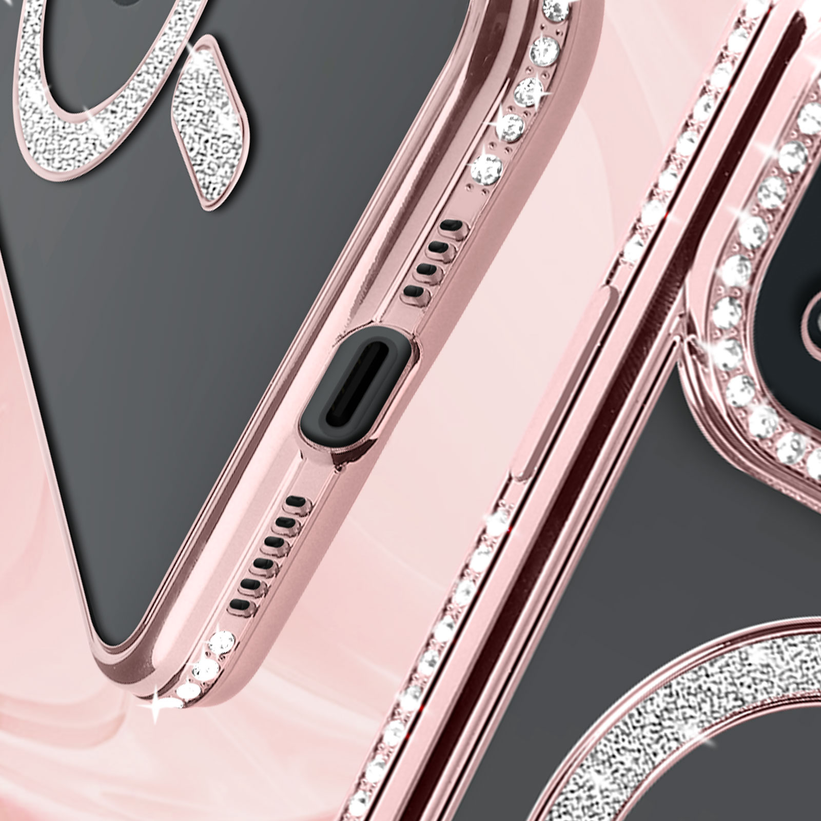 Primo piano di una custodia per telefono con cristalli. Schema di colori oro rosa e bianco.