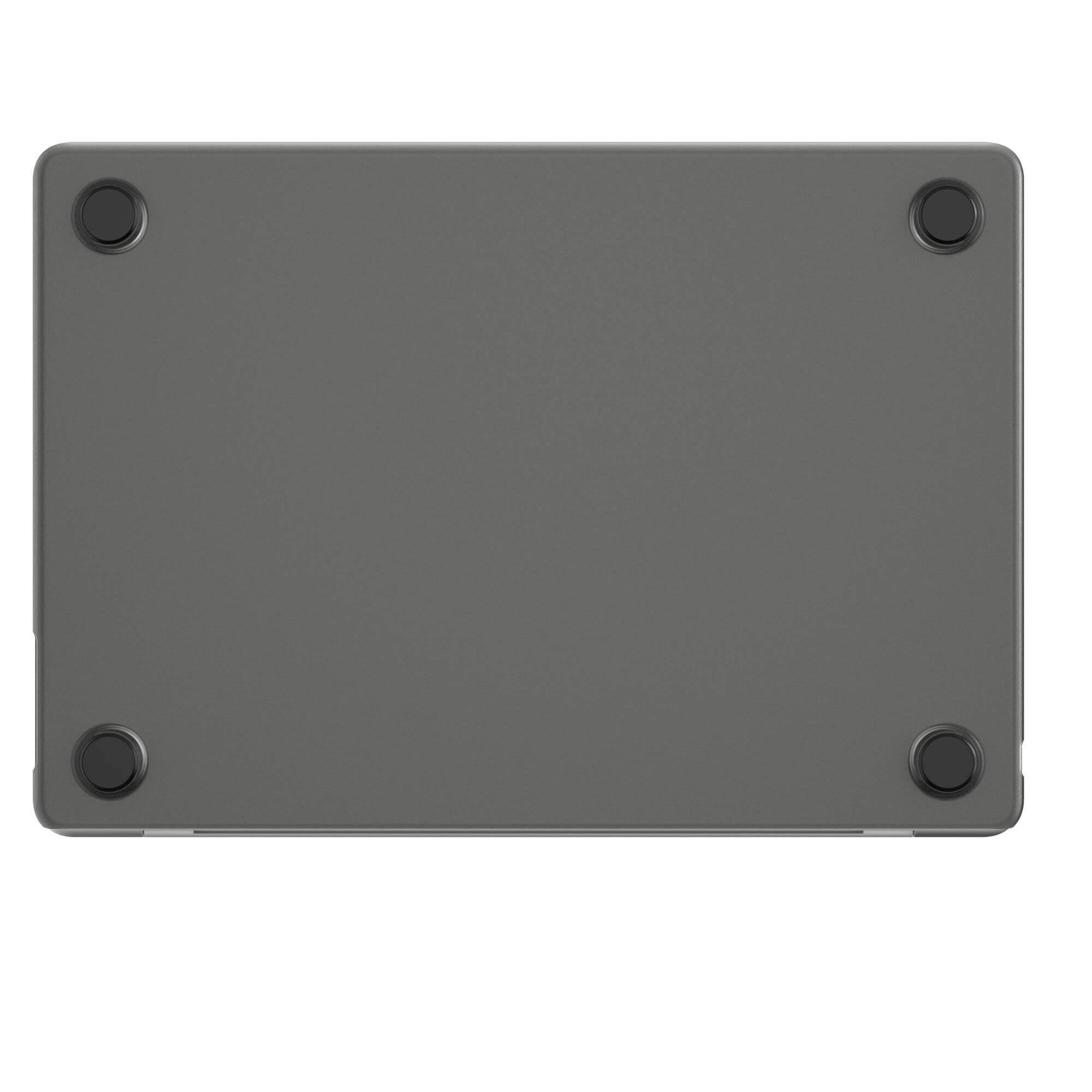 Fond de coque d'ordinateur portable gris avec quatre pieds en caoutchouc noir sur fond blanc.