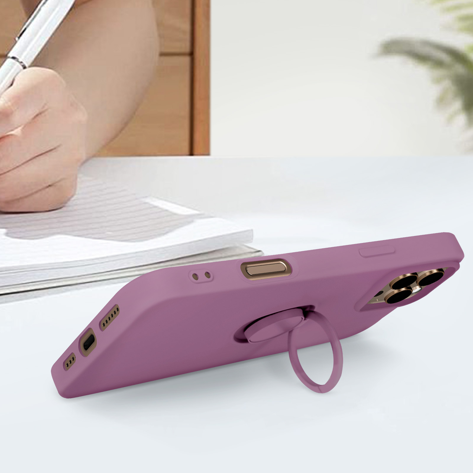 Custodia viola con anello di supporto. Telefono su superficie bianca, sfondo sfocato.