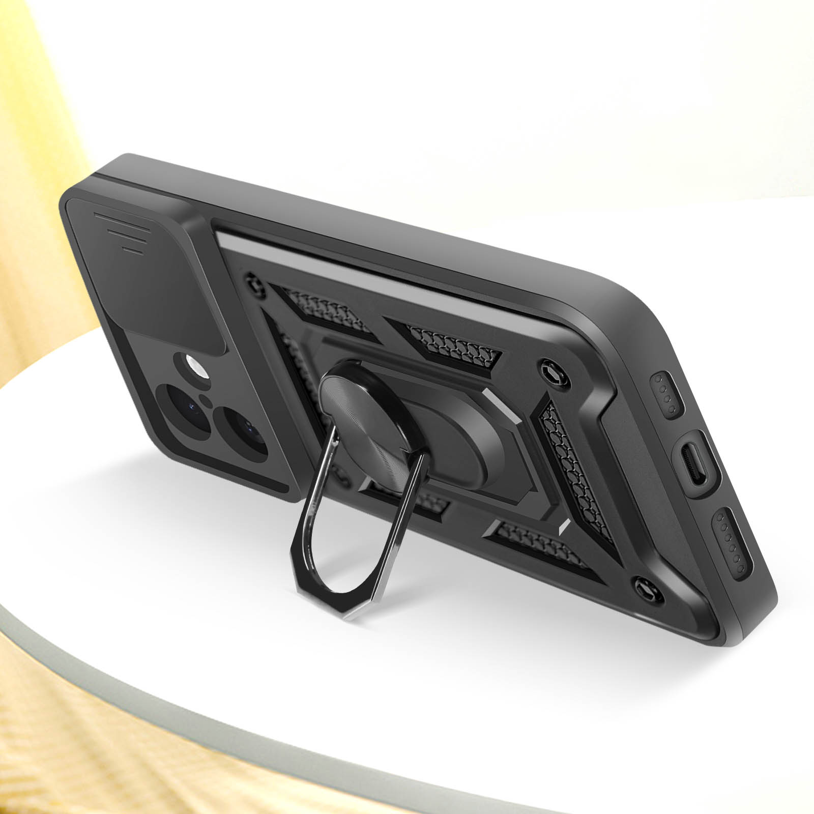 Custodia per telefono nera con supporto ad anello e copertura per fotocamera, su una superficie bianca.