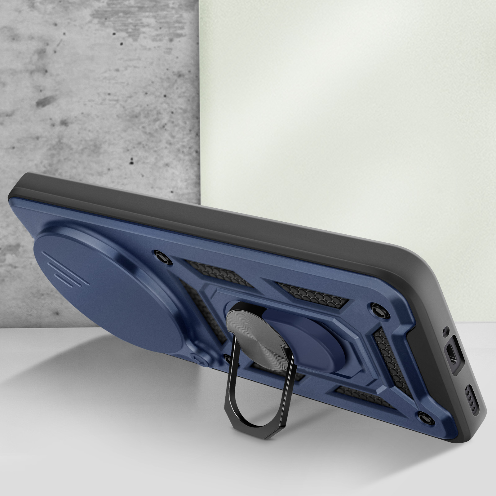 Custodia per telefono blu e nera con supporto ad anello, angolata su una superficie bianca con sfondo chiaro.