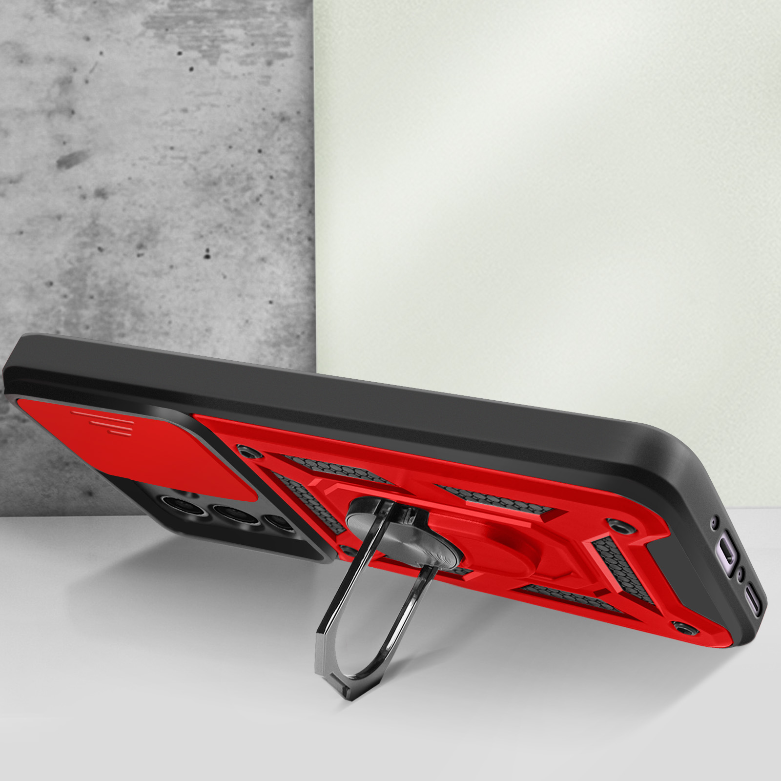 Custodia per telefono rossa e nera con supporto. Telefono su tavolo bianco.