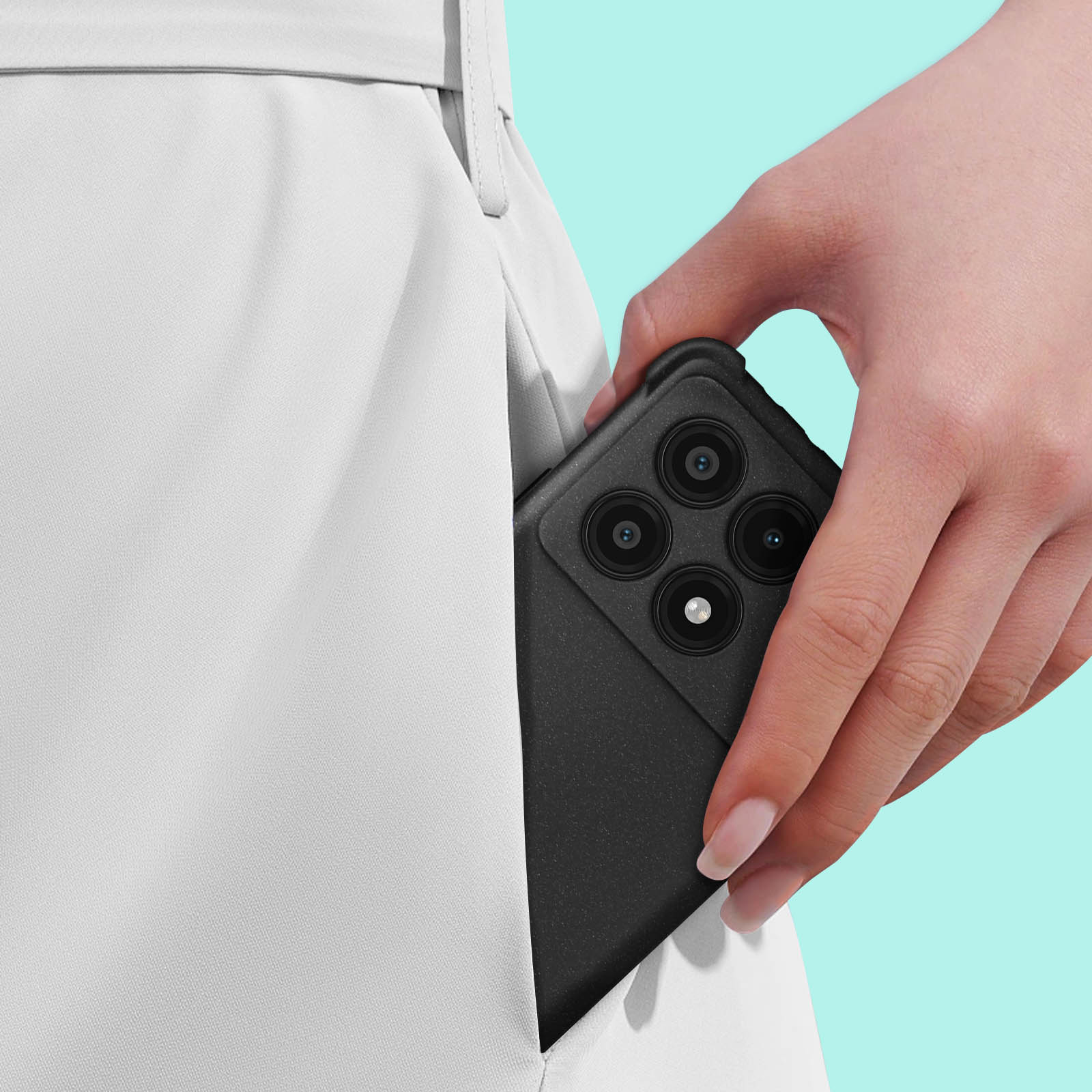 Un telefono in una custodia nera, in una tasca. La mano di una persona tiene il telefono. Pantaloni bianchi sullo sfondo.