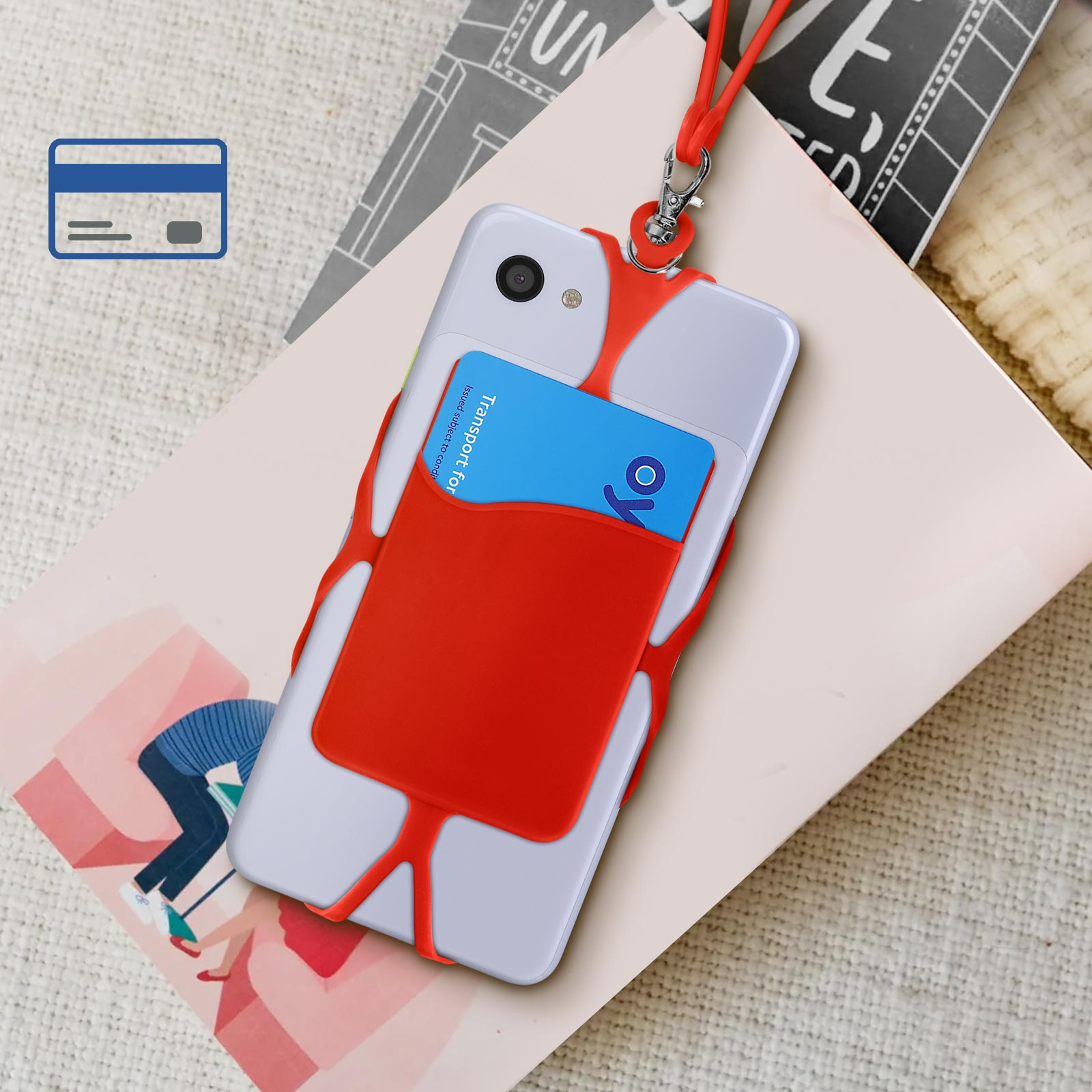 Un telefono con un cinturino rosso e una carta, posizionato su un taccuino. Un'icona di carta di credito nell'angolo.