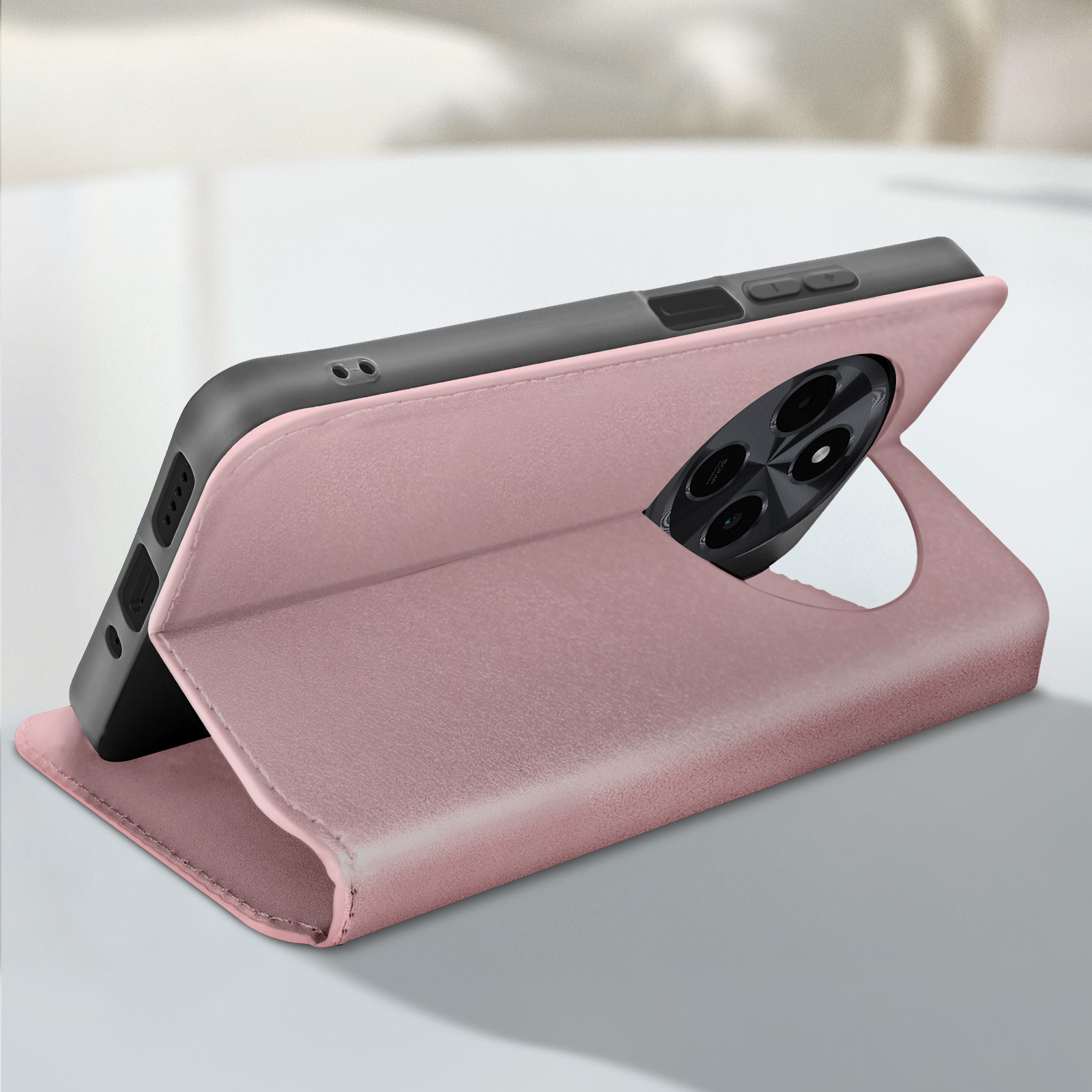 Custodia rosa per telefono, aperta con un telefono all'interno. Il telefono è appoggiato su un tavolo. Sfondo bianco.
