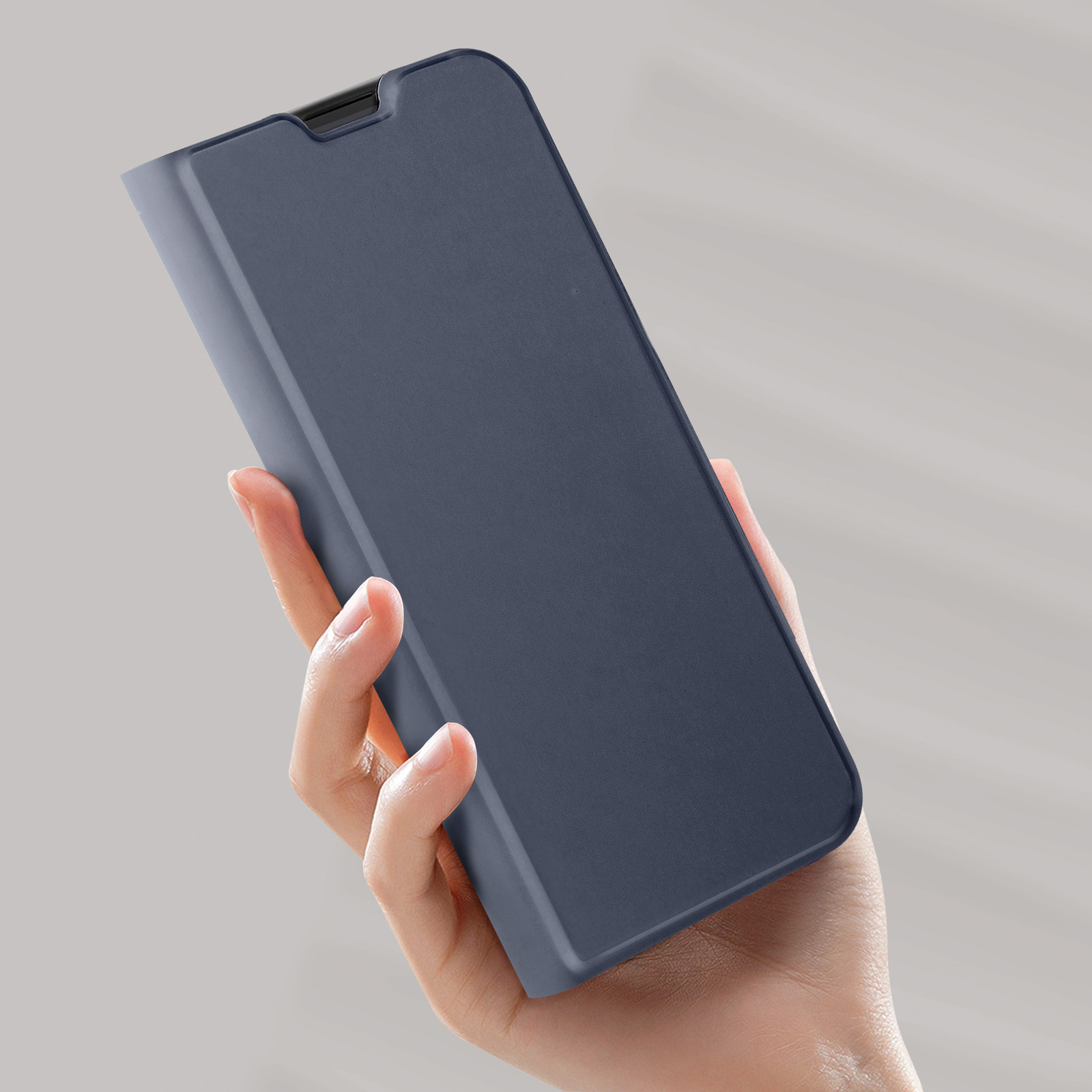 Persona che tiene in mano una custodia blu navy, mostrando la sua forma e il suo design.
