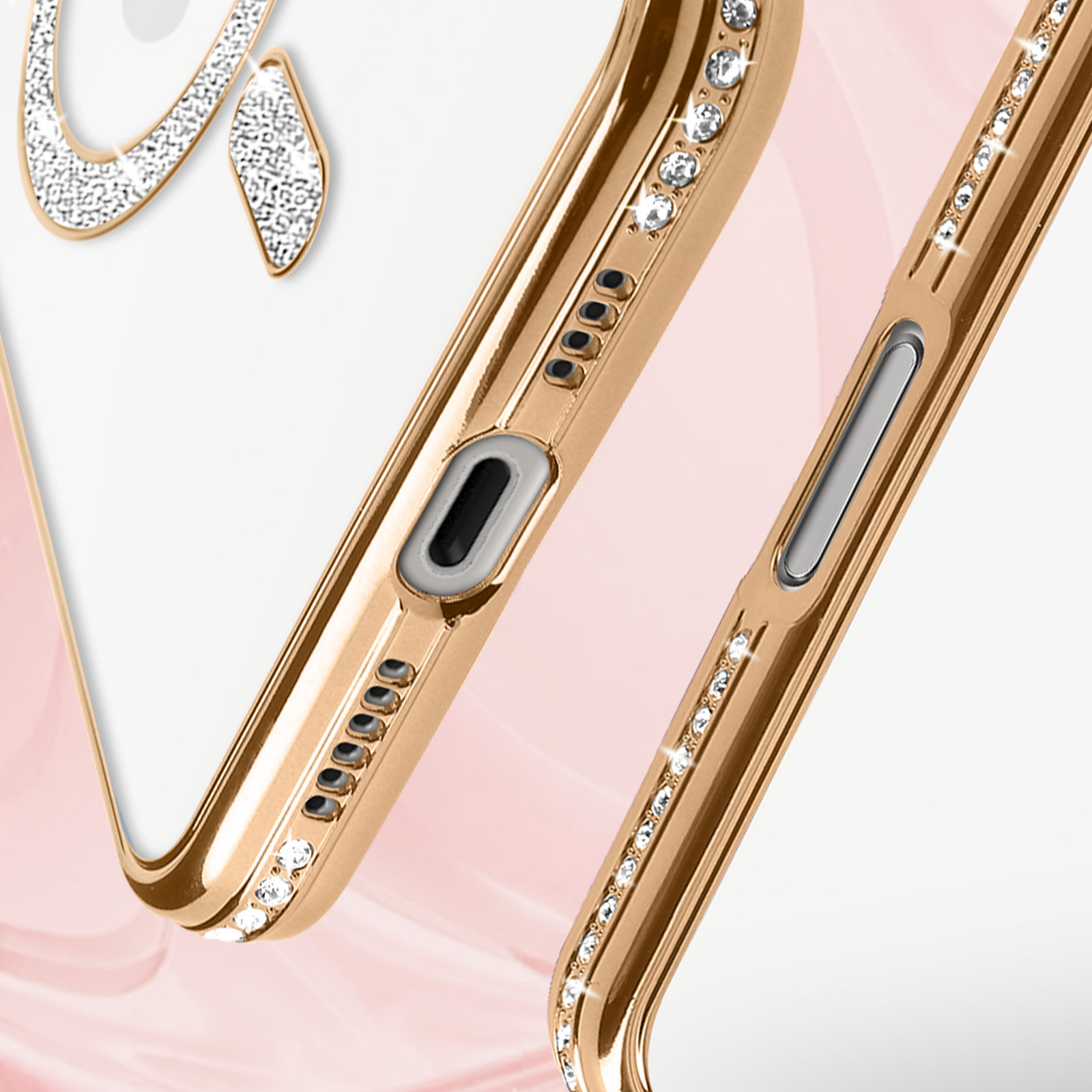 Nahaufnahme einer goldenen Handyhülle mit Diamanten. Die Hülle hat ein Apple-Logo.