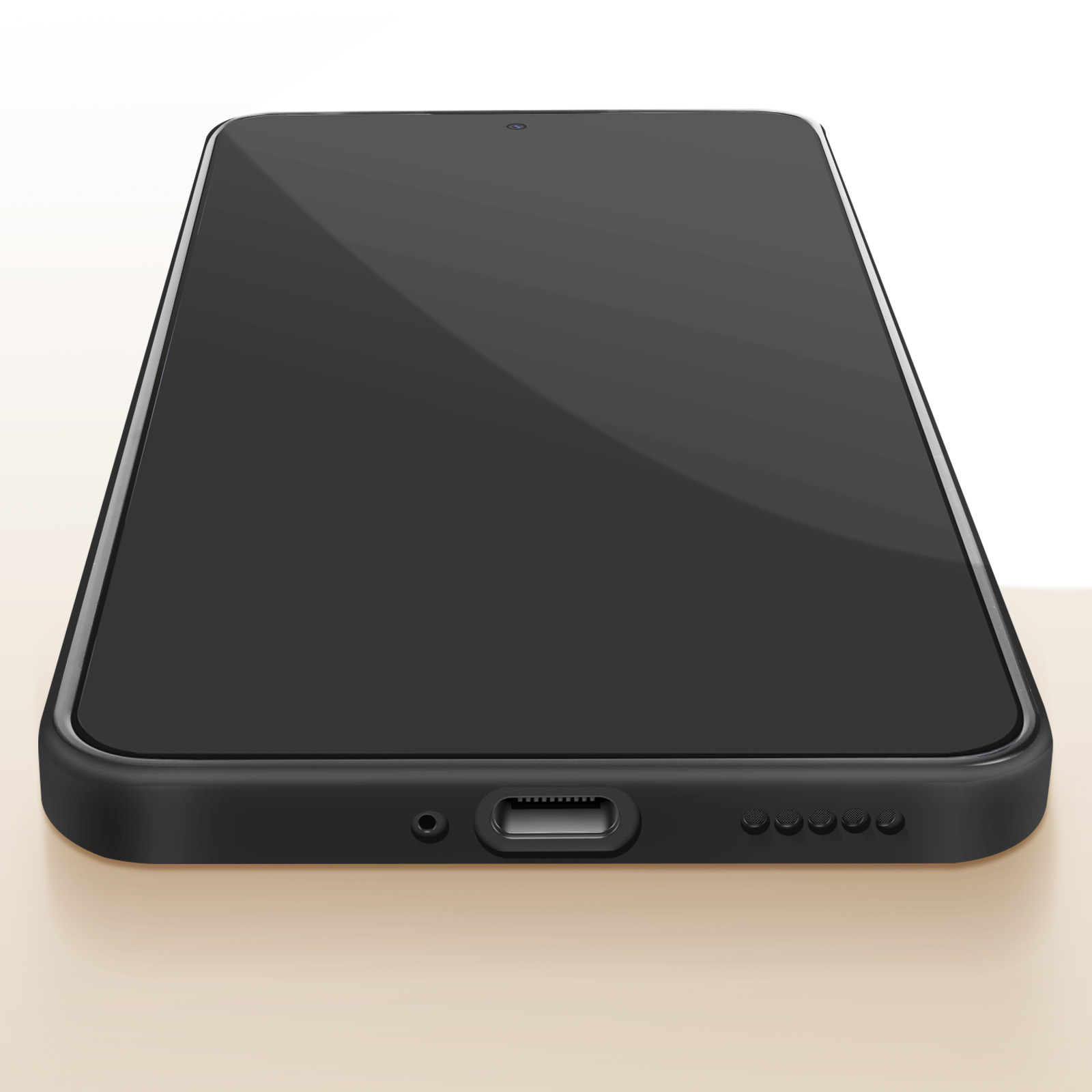Telefono nero su una superficie marrone chiaro. La parte inferiore del telefono è visibile.