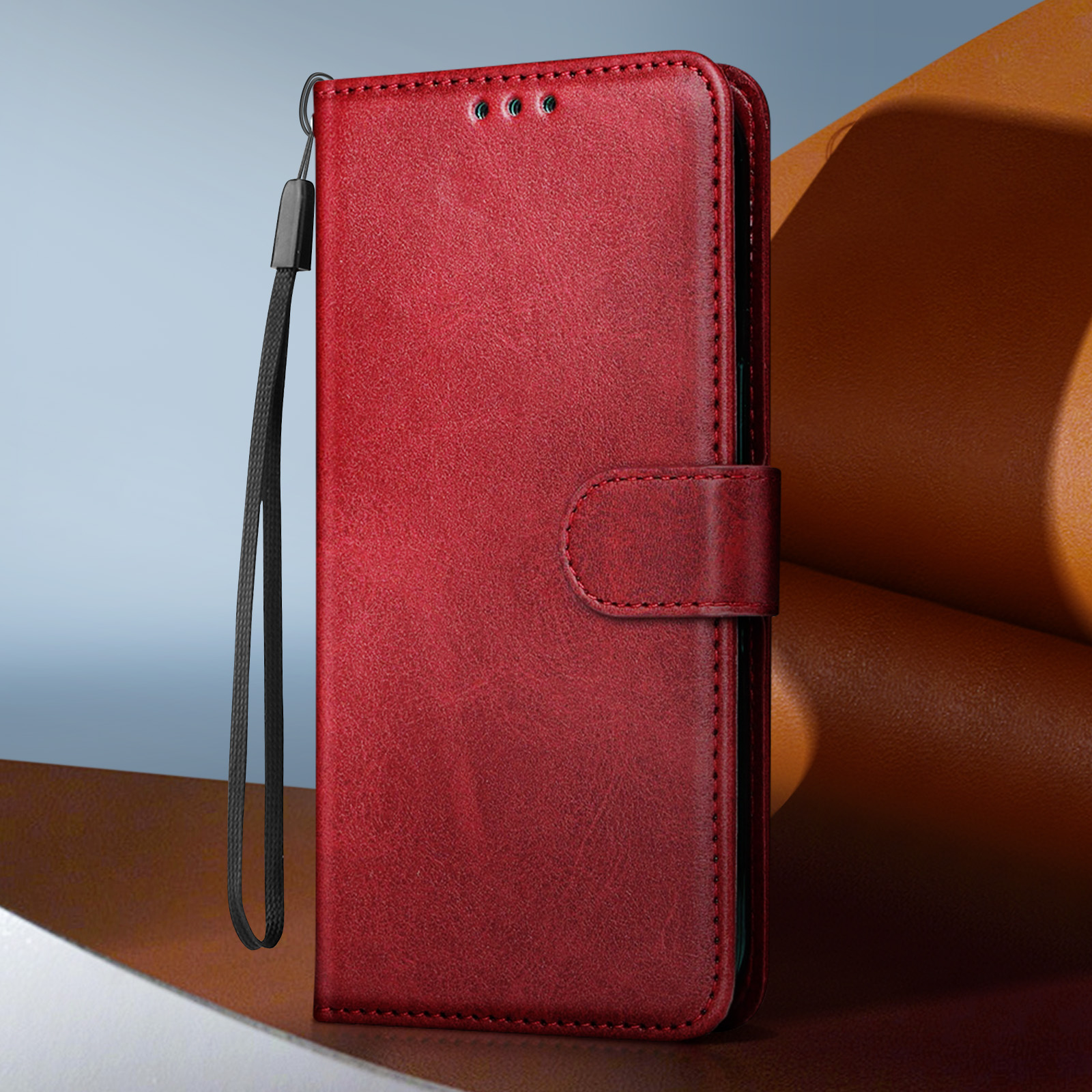 Custodia rossa per telefono con cinturino. La custodia è aperta, mostrando il telefono all'interno.